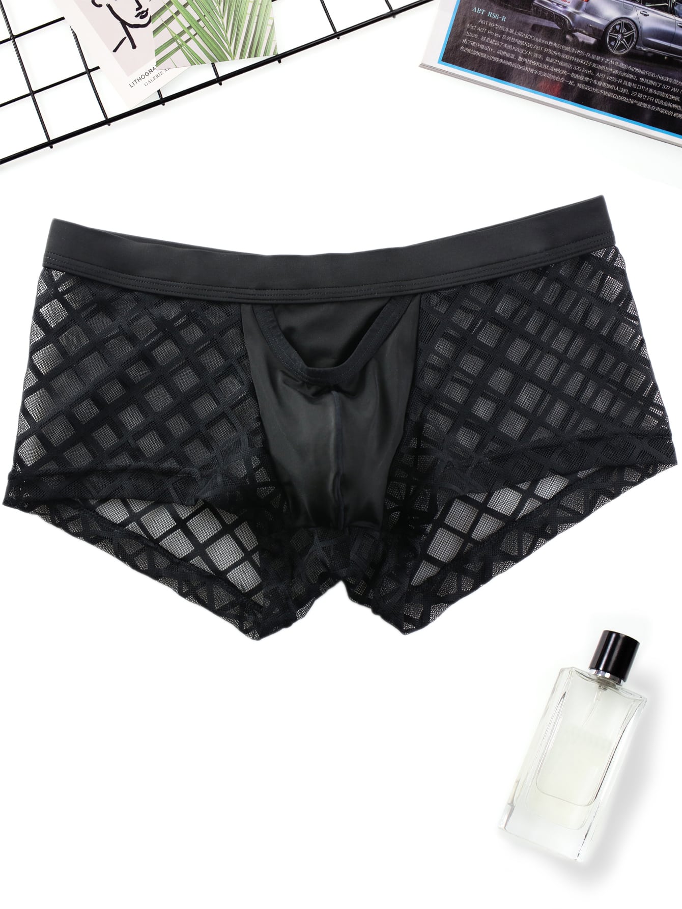 Men's black low-rise plaid mesh panel boxer brief with semi-sheer fabric and high-stretch fit