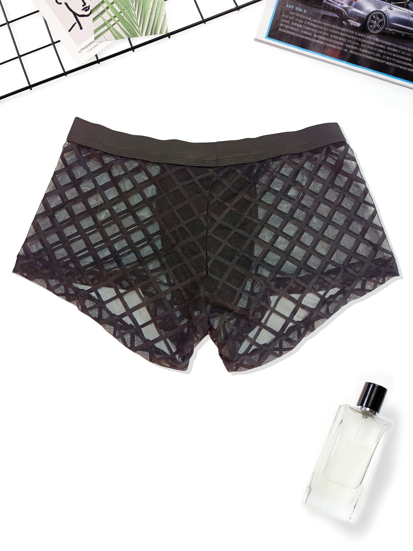 Men's black low-rise plaid mesh panel boxer brief with semi-sheer fabric and high-stretch fit