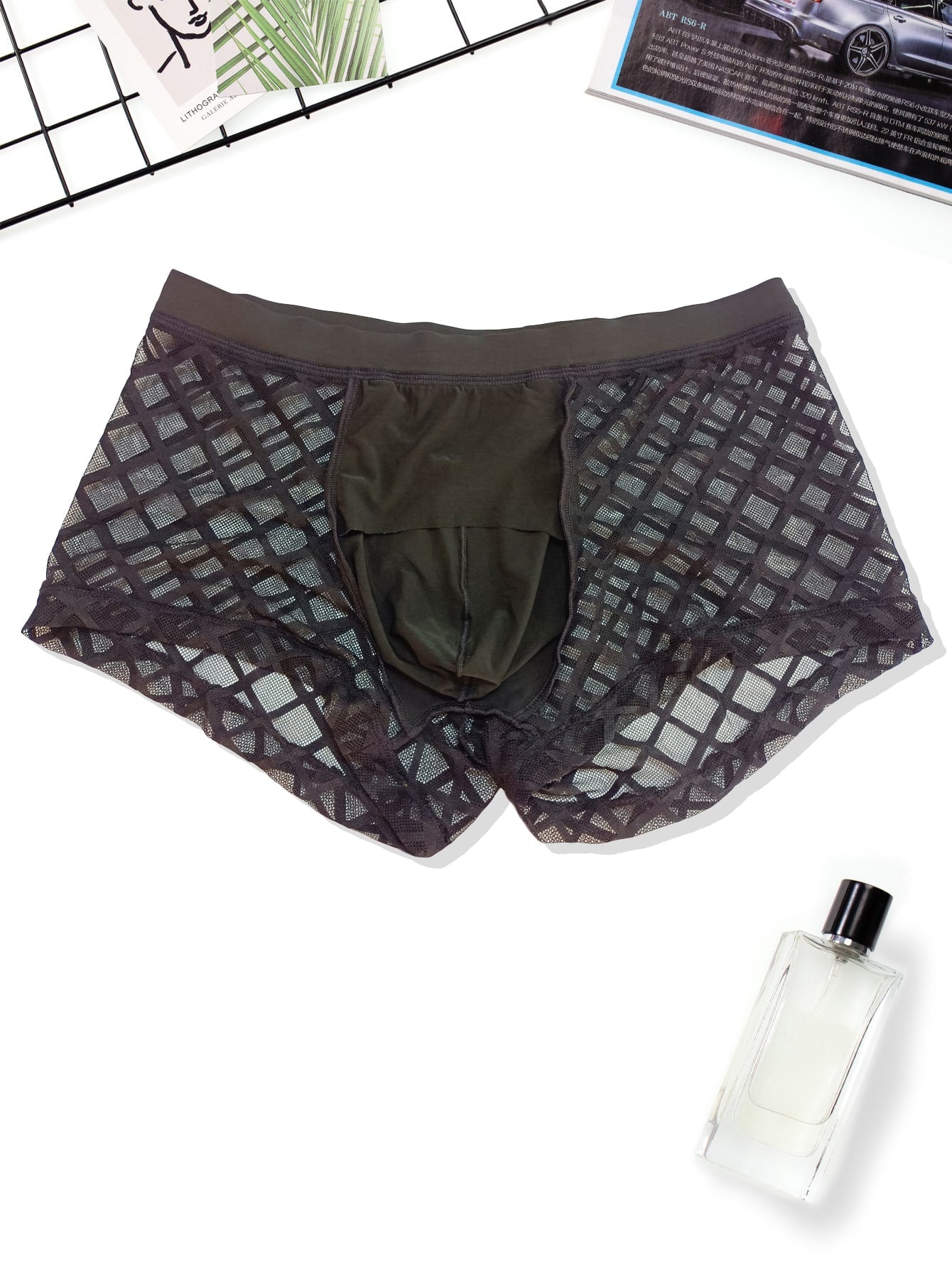 Men's black low-rise plaid mesh panel boxer brief with semi-sheer fabric and high-stretch fit