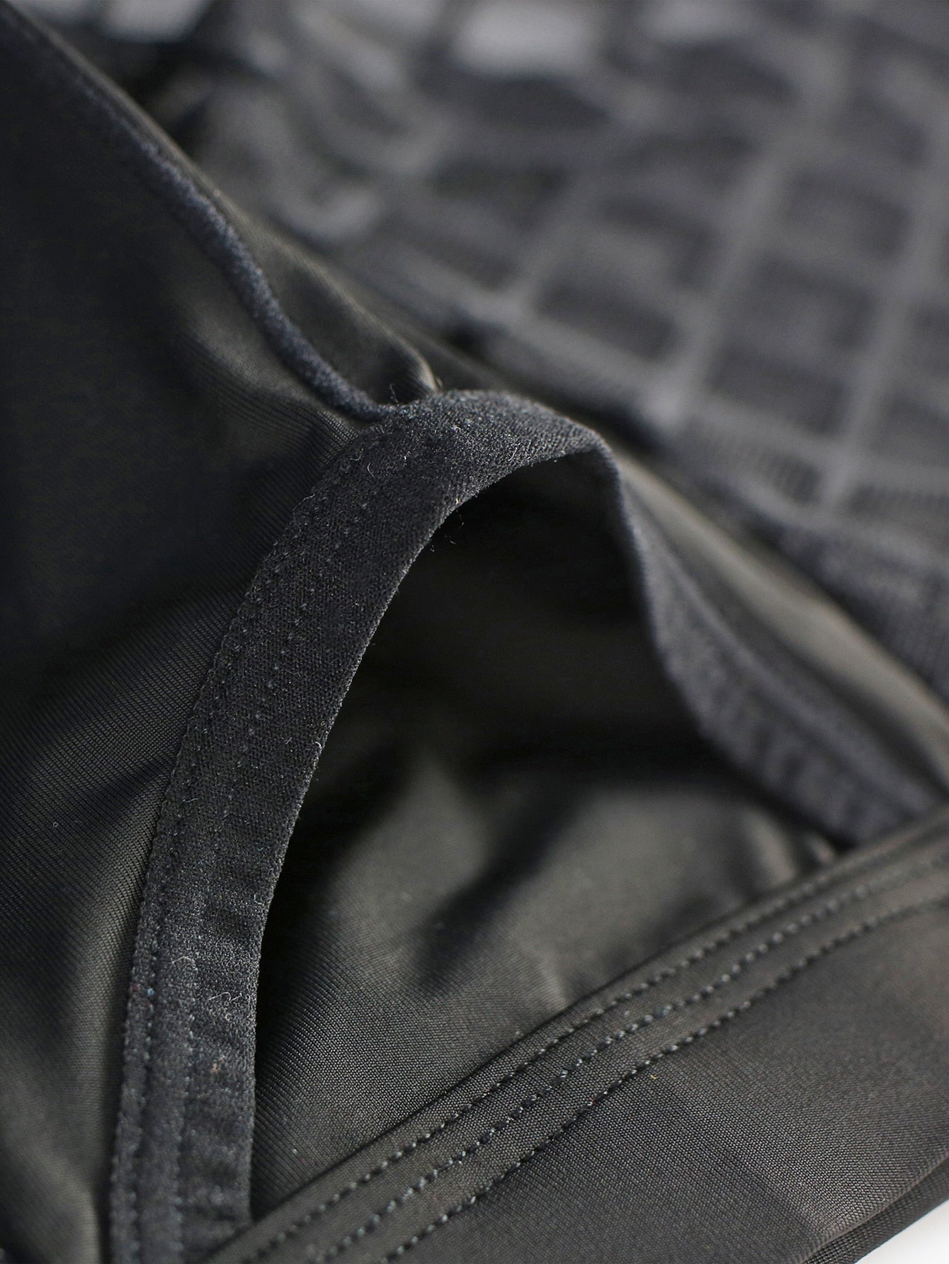 Men's black low-rise plaid mesh panel boxer brief with semi-sheer fabric and high-stretch fit