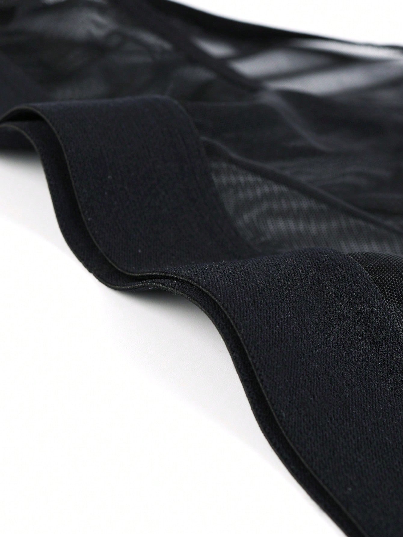 Men's black mesh triangle briefs with mid-rise cut and medium-stretch fabric