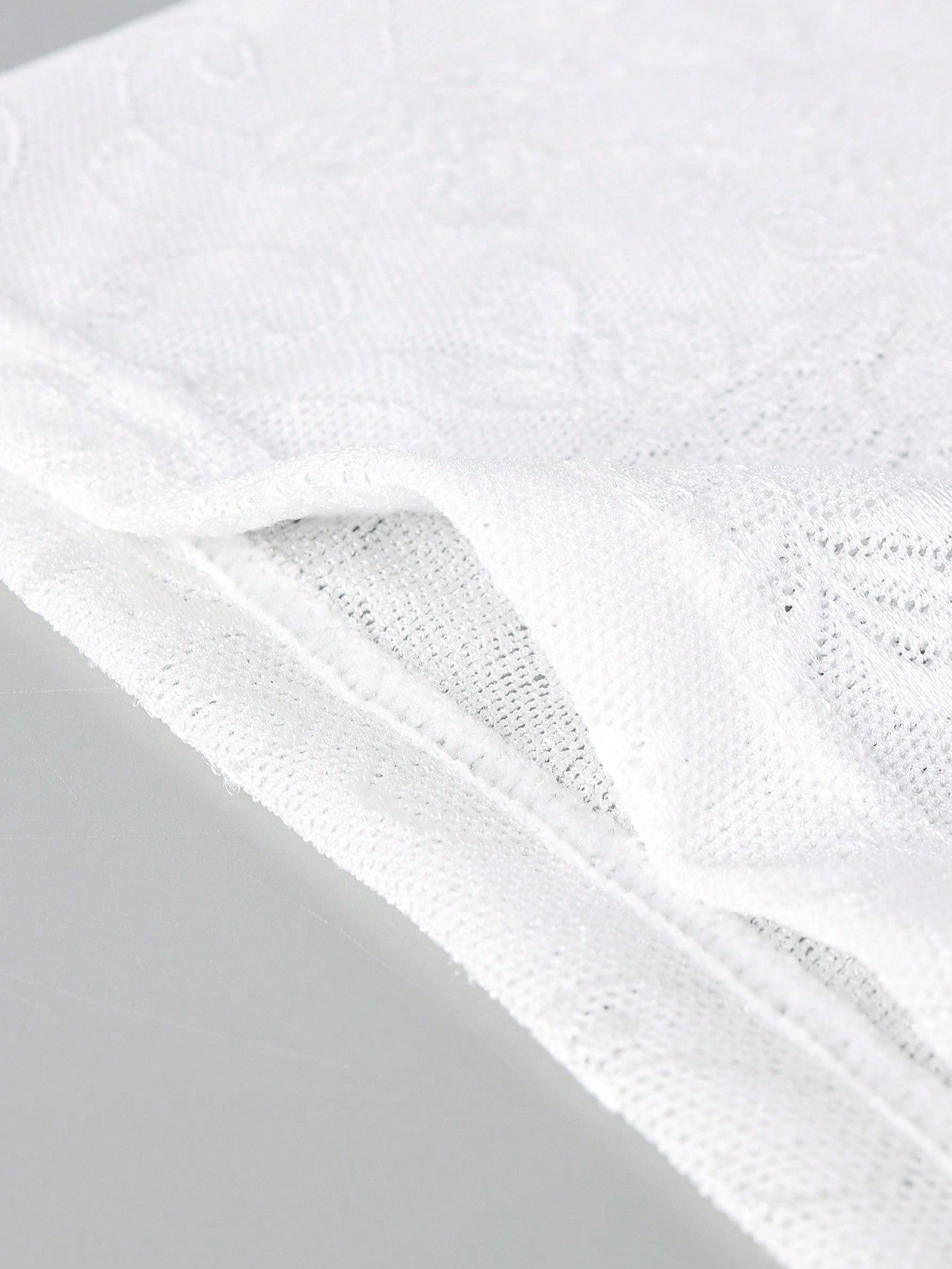 Men's black low-rise mesh boxer shorts with contrast lace details and a plain design
