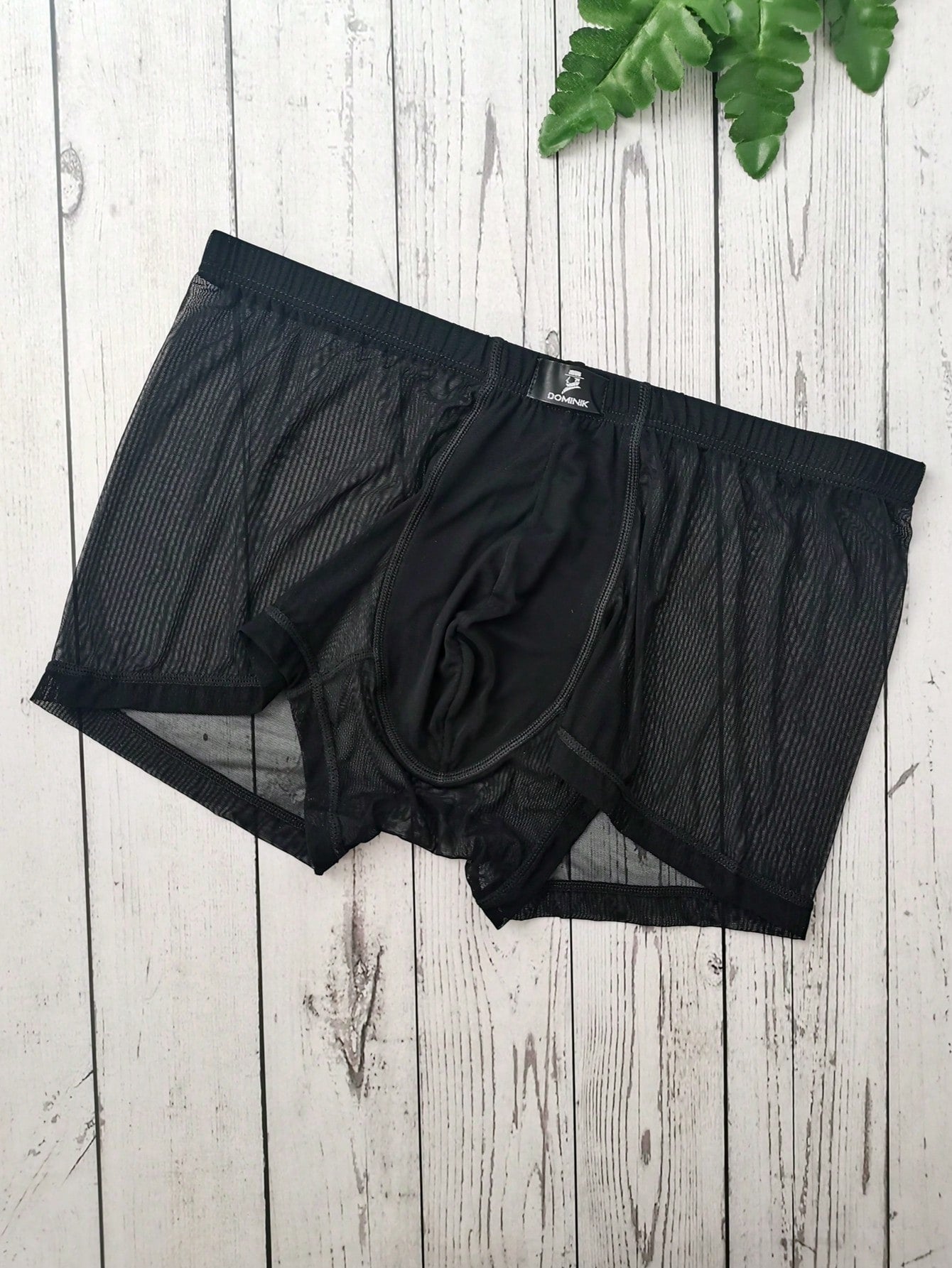 Men's black semi-sheer mesh low-rise trunks with contrast binding and high-stretch fabric