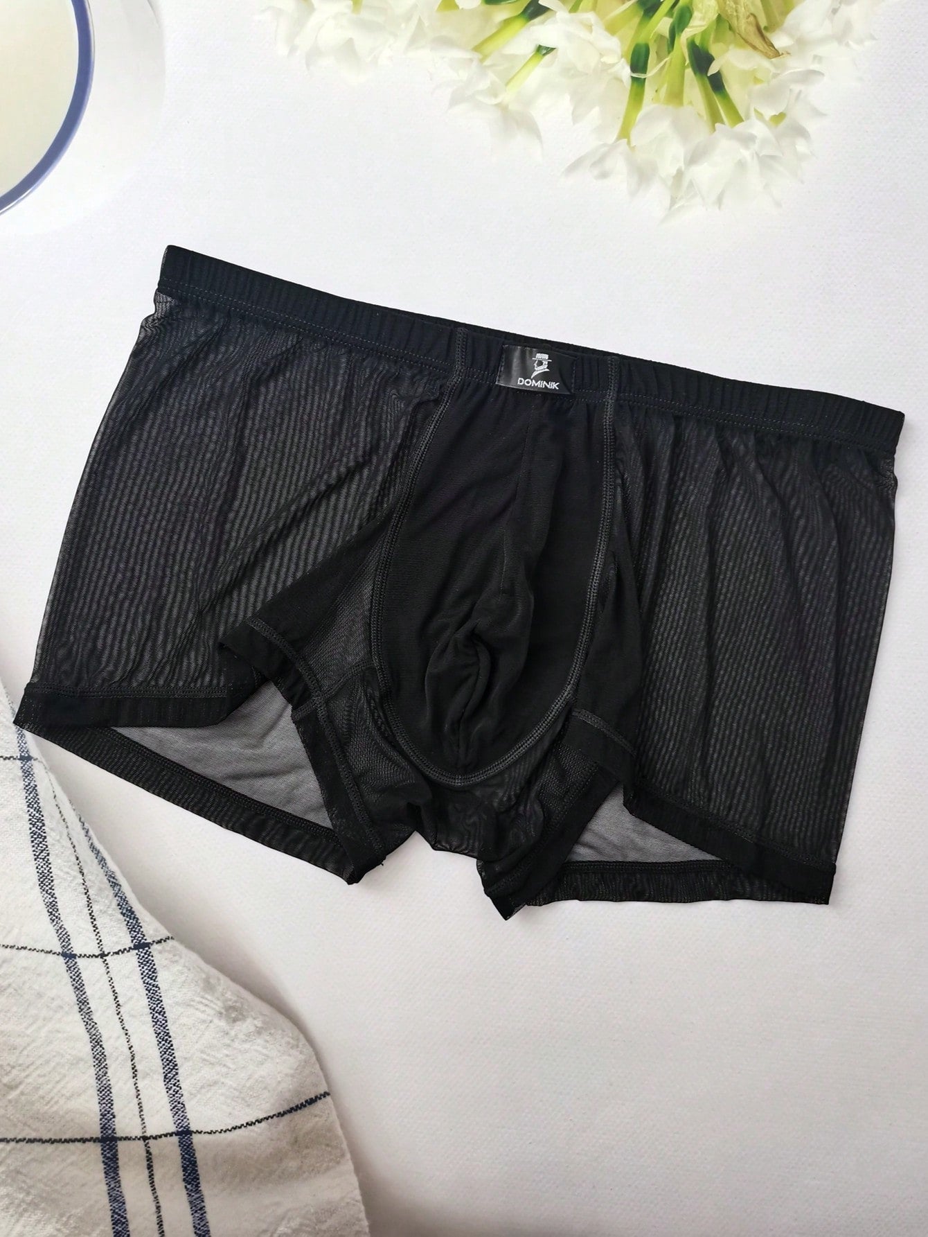 Men's black semi-sheer mesh low-rise trunks with contrast binding and high-stretch fabric