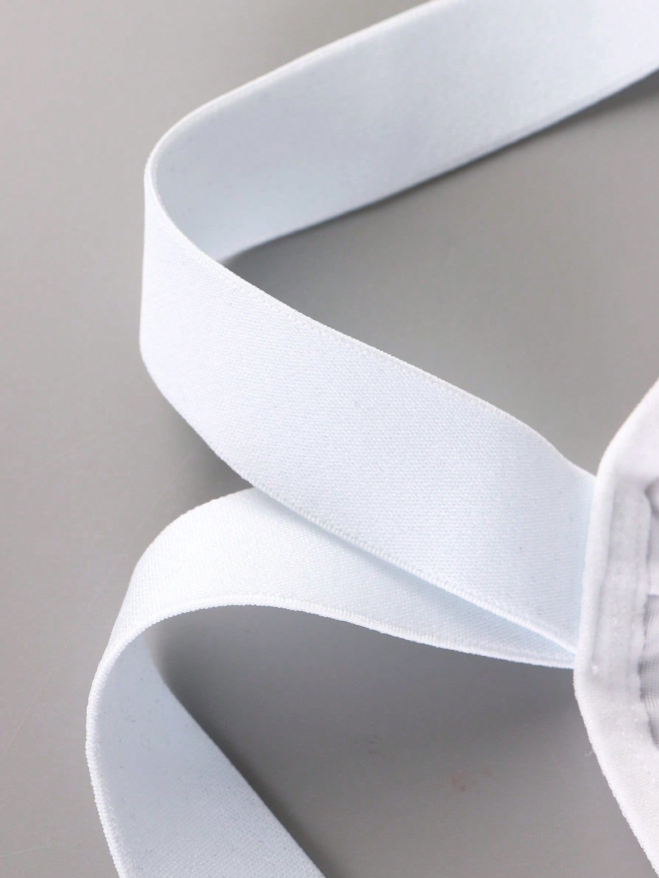 Men's white plain daily G-string underwear with tape detail, mid-rise fit, and minimal jockstrap-style design