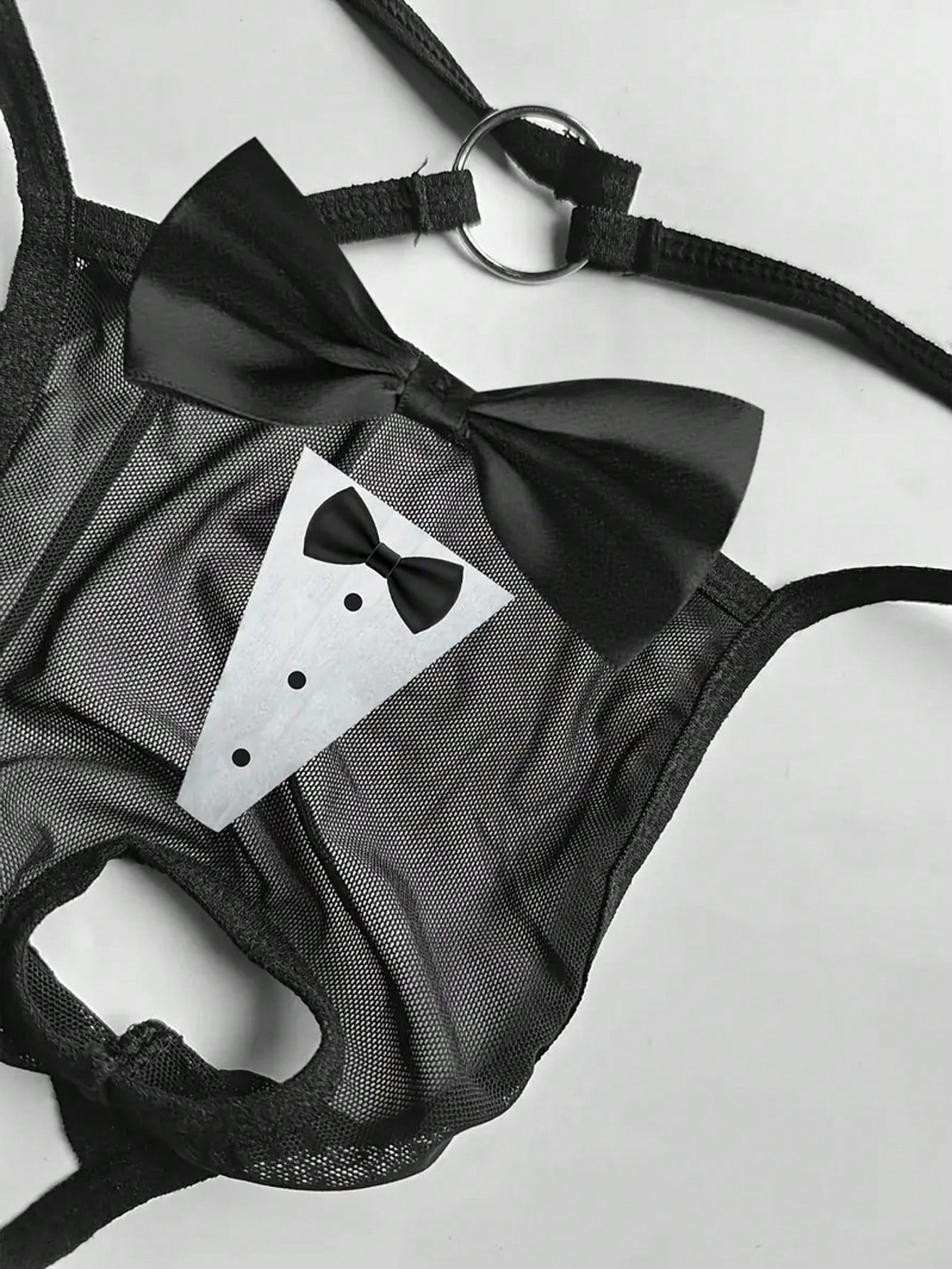 Men's black sheer mesh thong underwear with Halloween bow print pattern, bow decor, and cut-out details