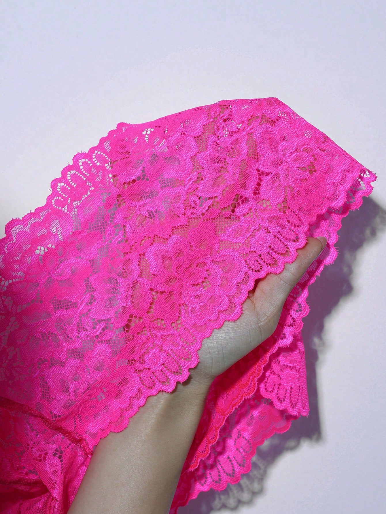Men's hot pink floral lace low-rise briefs with semi-sheer lace, bow detail, and contrast lace trim