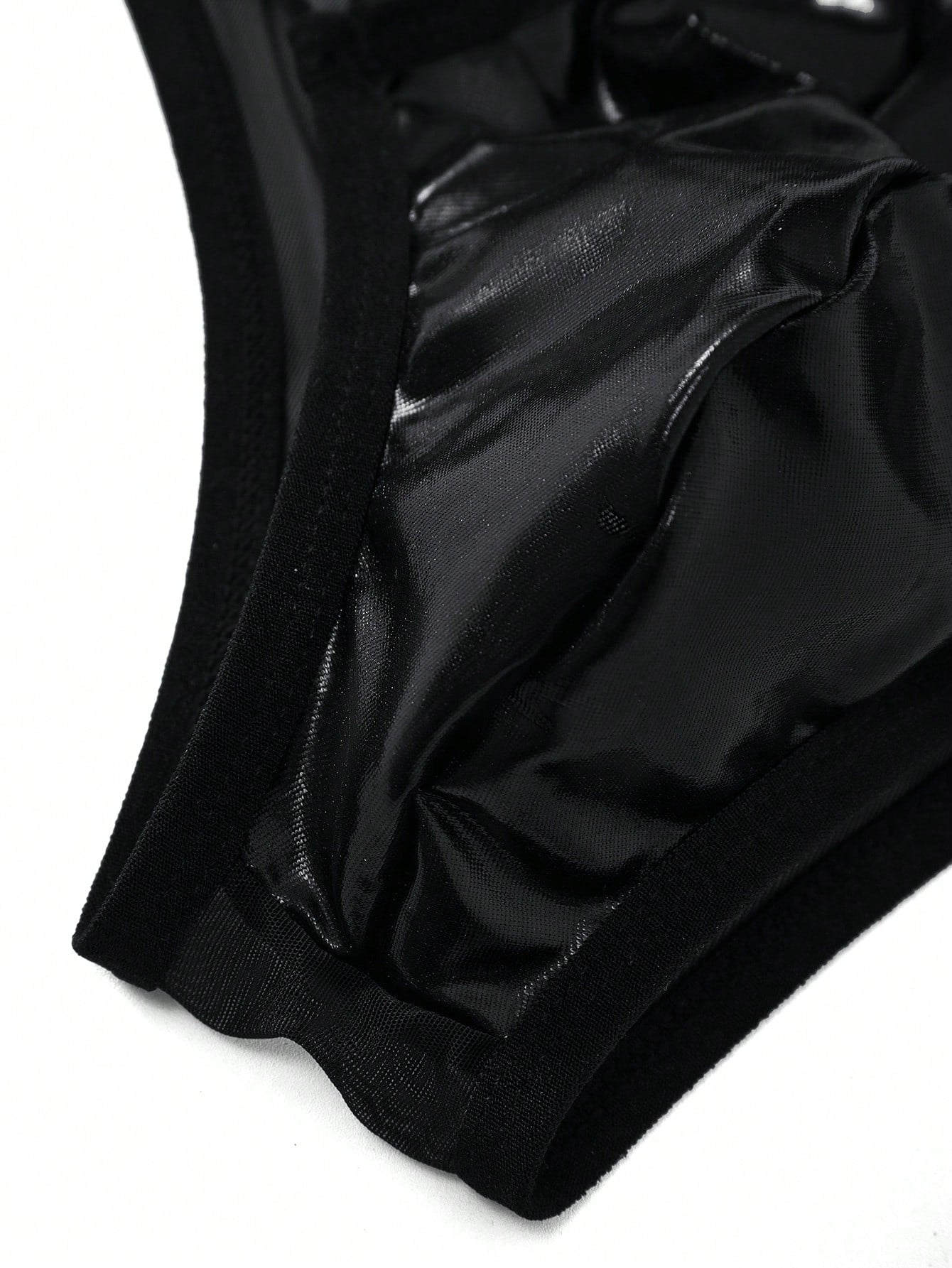 Men's black low-rise briefs with bow tie and pearl decor, colorblock styling, semi-sheer unlined body, and 3D pouch design.