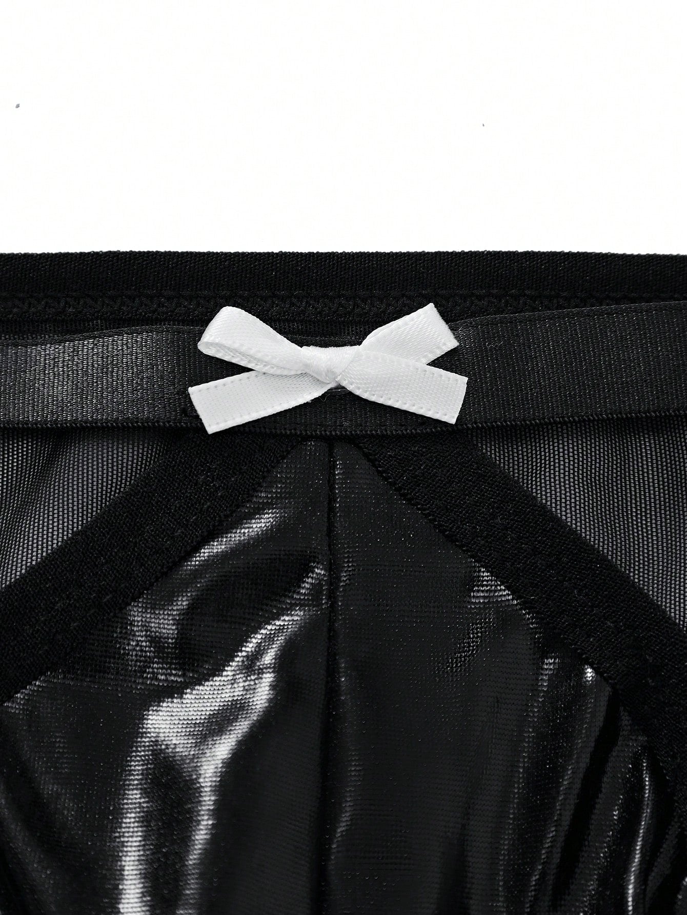 Men's black low-rise briefs with bow tie and pearl decor, colorblock styling, semi-sheer unlined body, and 3D pouch design.