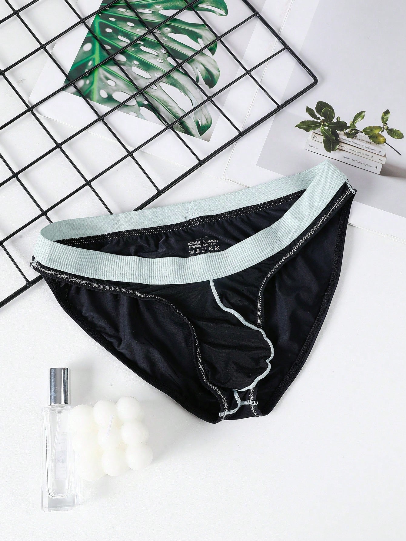 Men's low rise briefs with pouch, backless cut-out design, elastic waist, and contrast binding