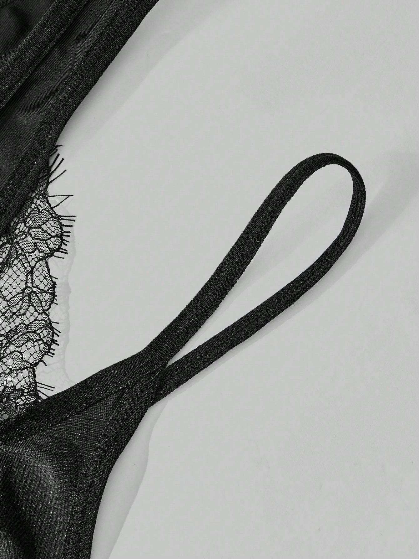 Men's black lace low-rise thong underwear in a plain unlined design