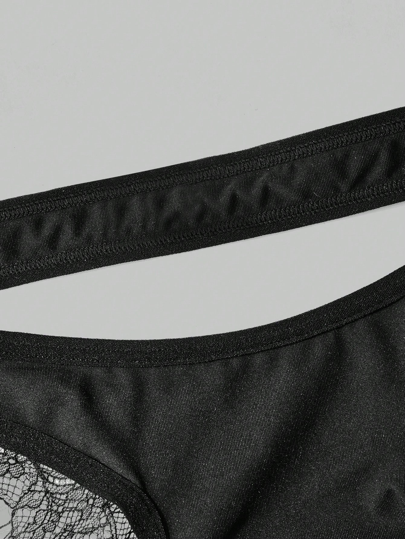 Men's black lace low-rise thong underwear in a plain unlined design
