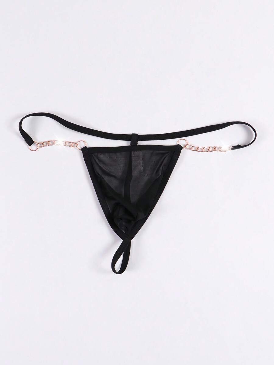 Black men's low rise thong underwear featuring semi-sheer knitted fabric, cut out design, contrast binding, and metallic chain decor.