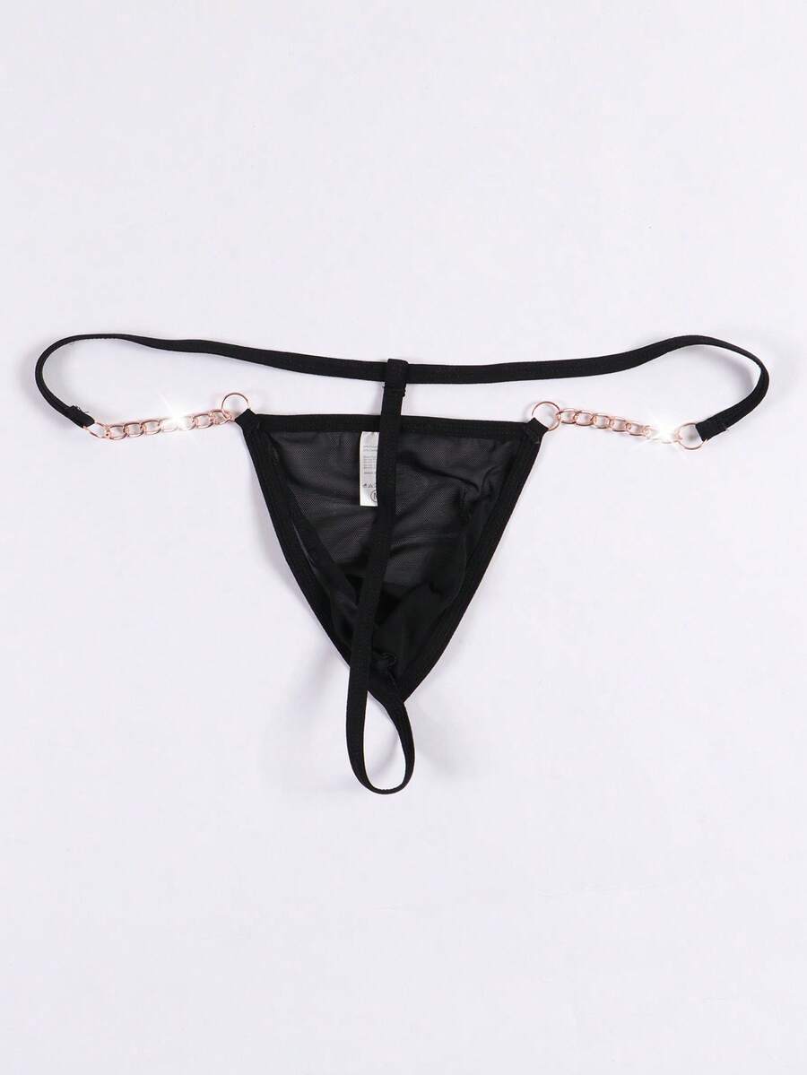 Black men's low rise thong underwear featuring semi-sheer knitted fabric, cut out design, contrast binding, and metallic chain decor.