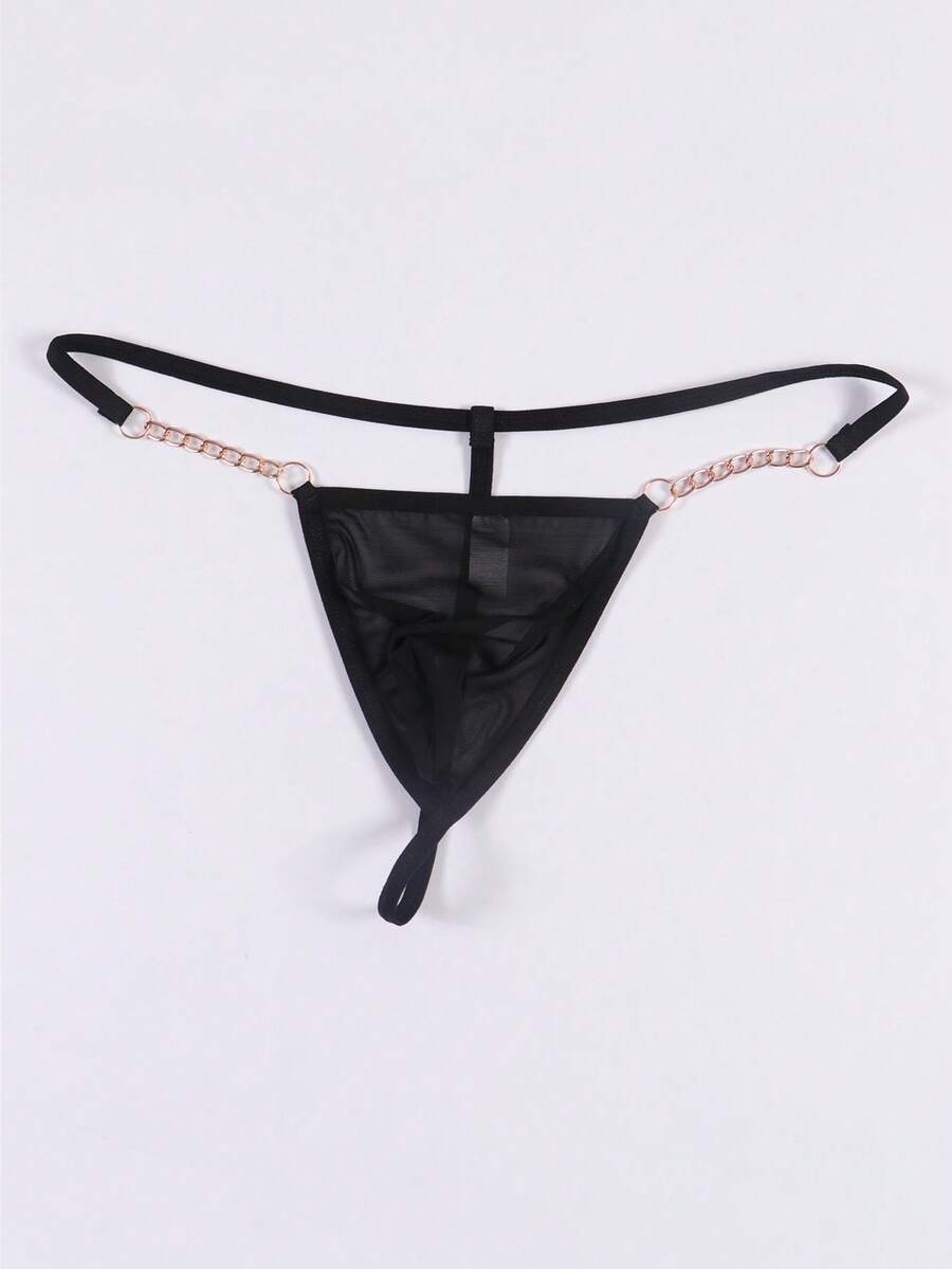 Black men's low rise thong underwear featuring semi-sheer knitted fabric, cut out design, contrast binding, and metallic chain decor.