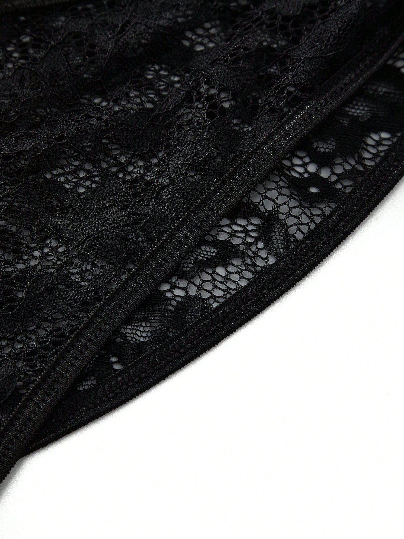 Men's black low-rise lace jockstrap thong underwear with hollow-out details and semi-sheer fabric