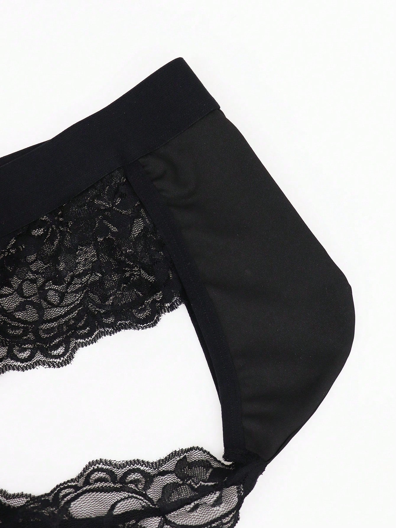 Men's black lace wave thong briefs with plant pattern detail and mid-rise styling