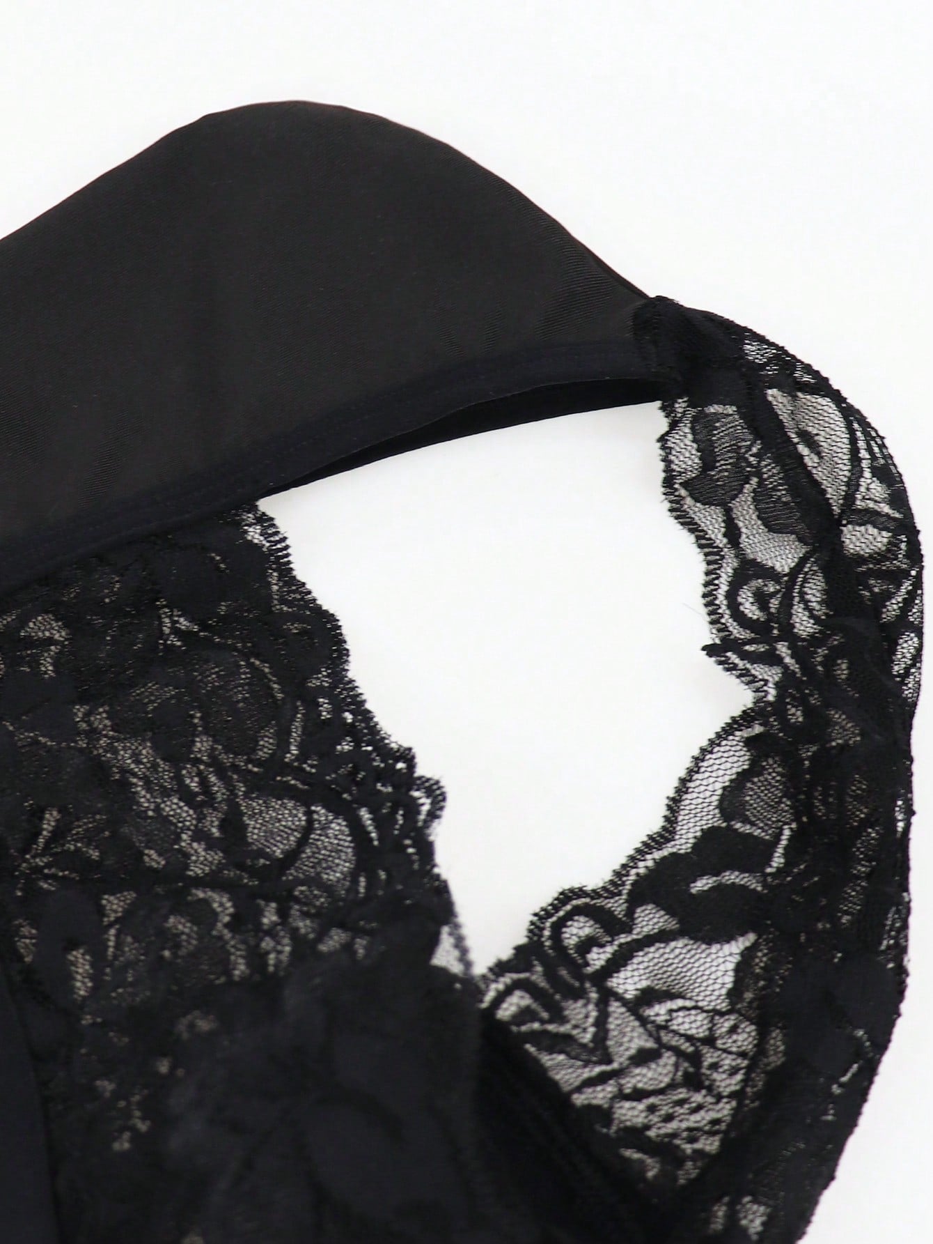 Men's black lace wave thong briefs with plant pattern detail and mid-rise styling