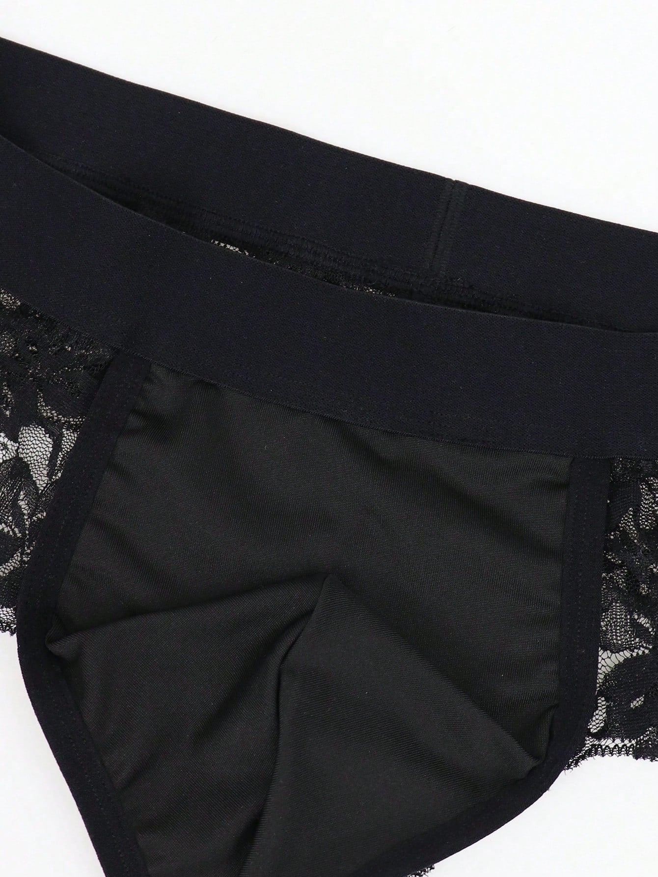 Men's black lace wave thong briefs with plant pattern detail and mid-rise styling