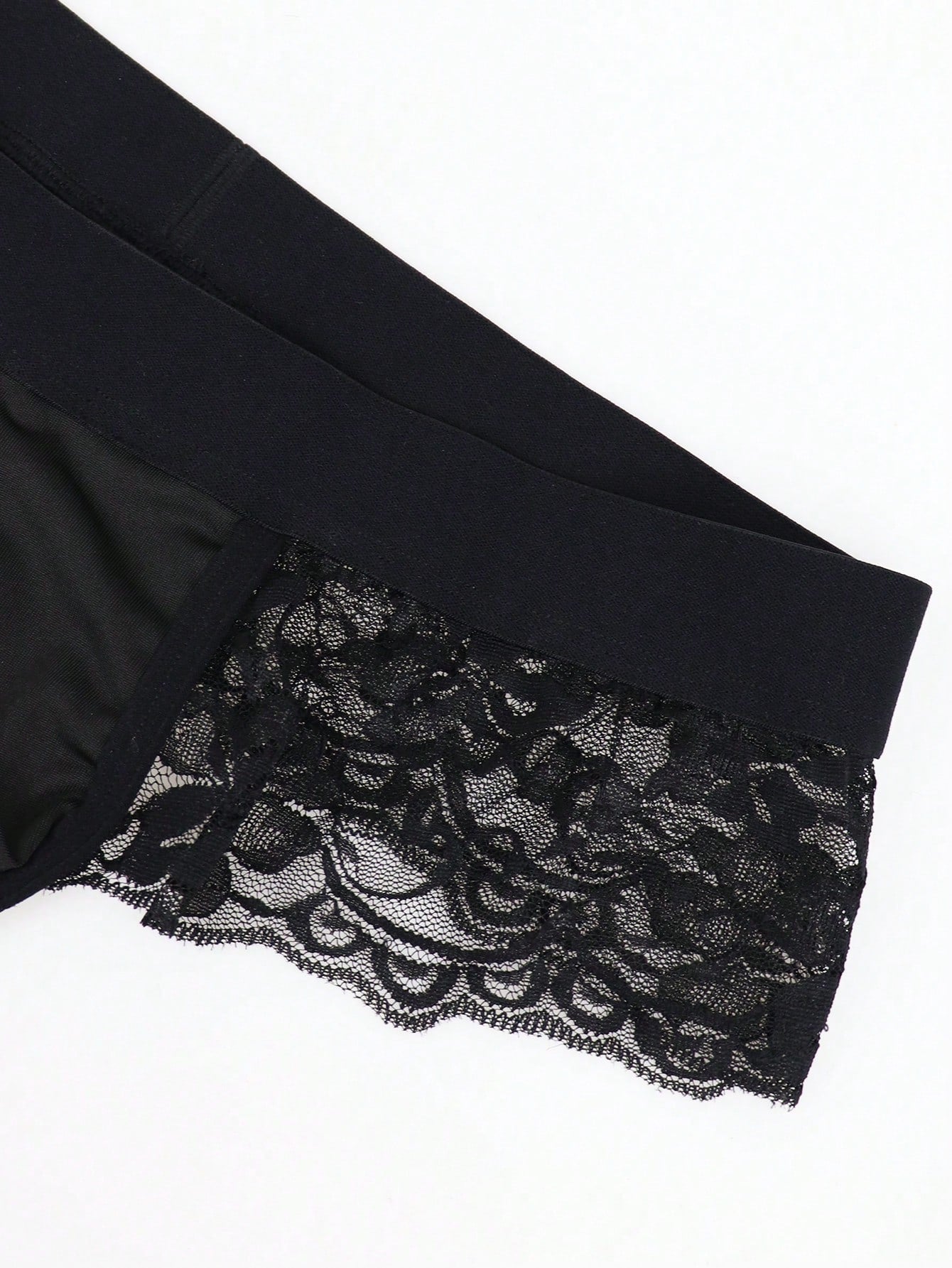 Men's black lace wave thong briefs with plant pattern detail and mid-rise styling