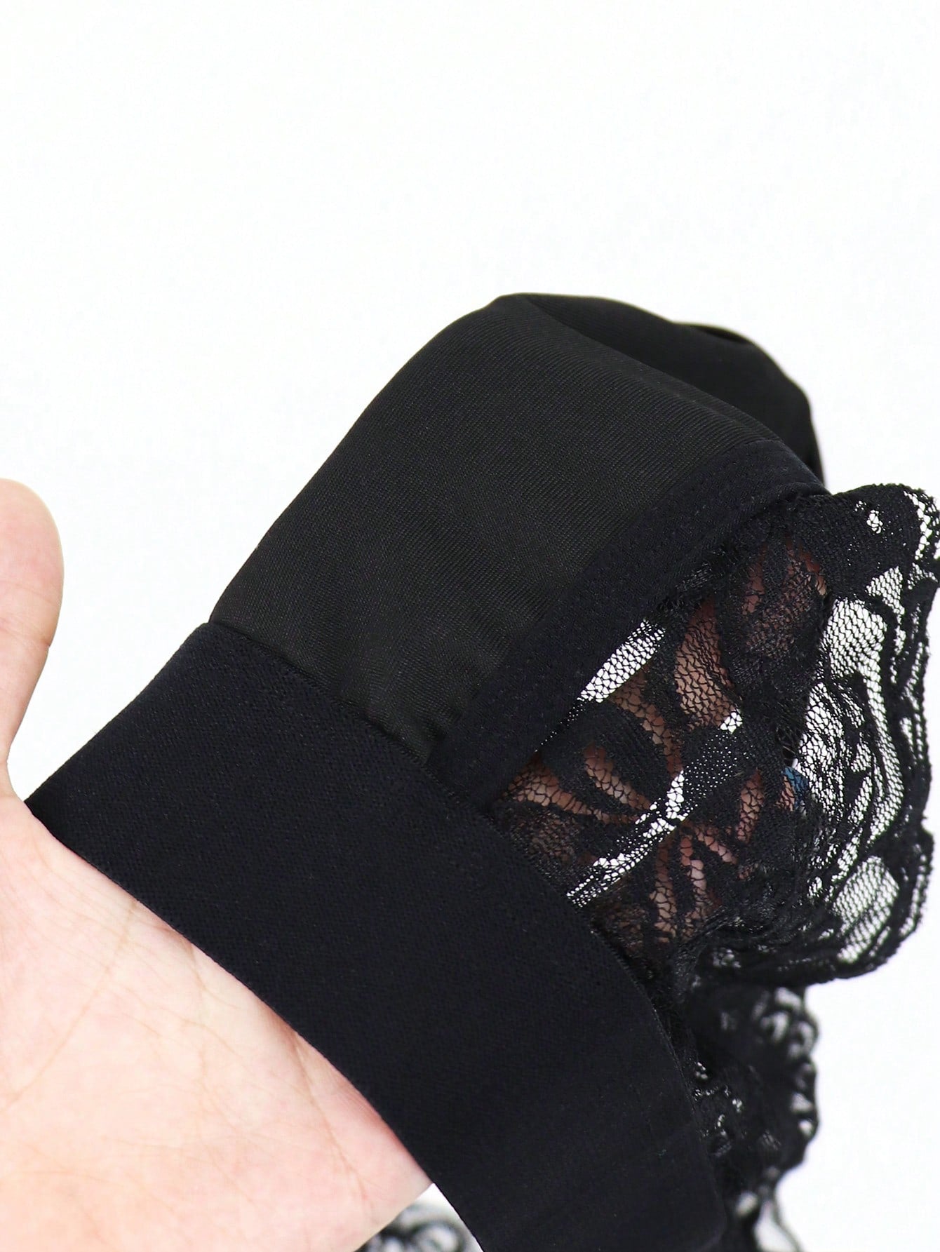 Men's black lace wave thong briefs with plant pattern detail and mid-rise styling