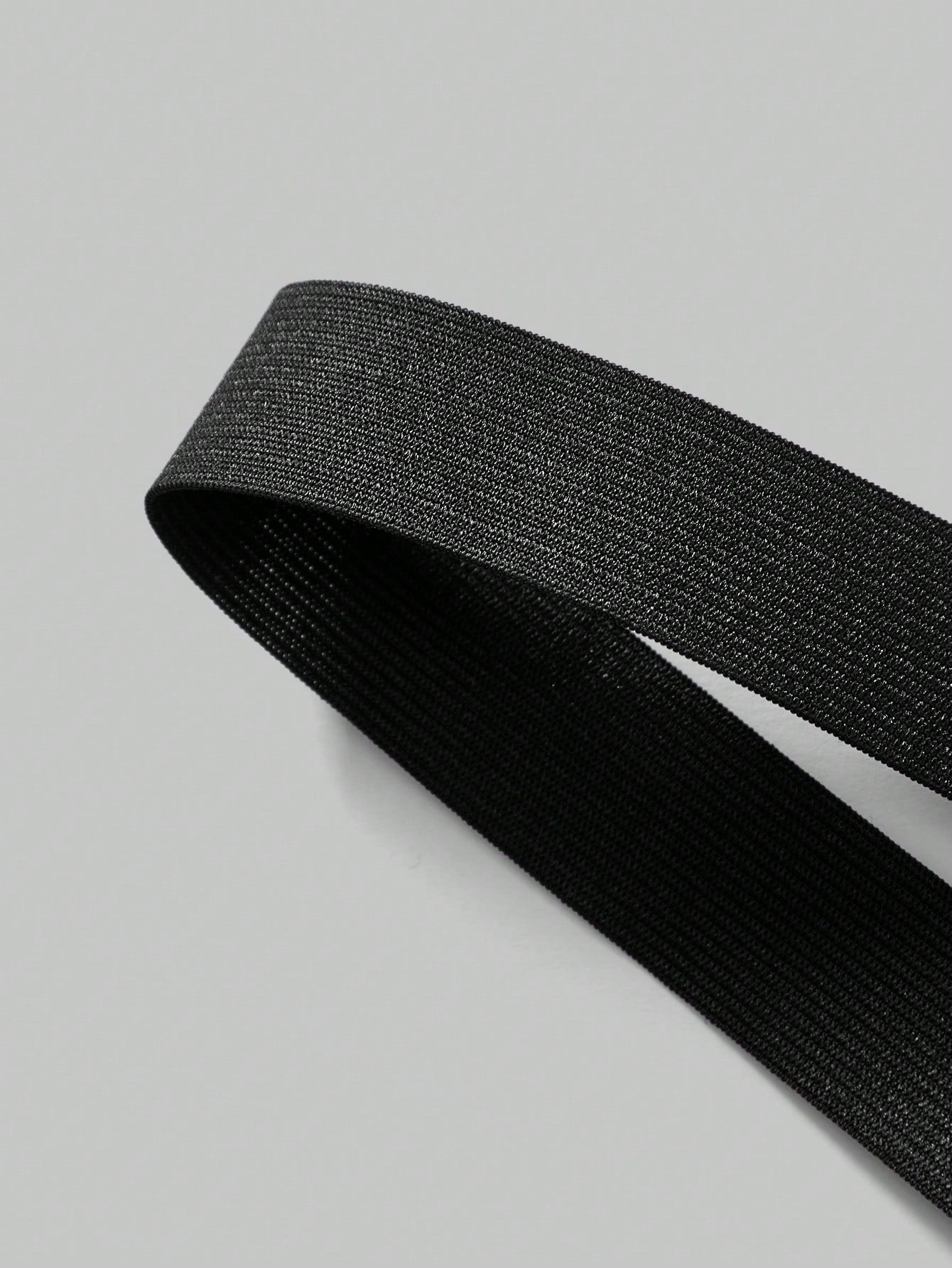 Men's black low-rise thong underwear with a plain solid color design