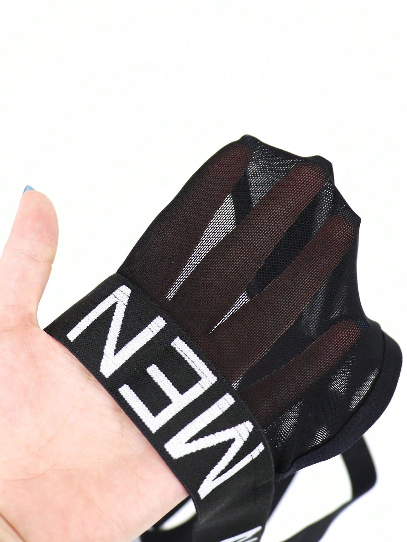 Men's black low-rise jockstrap briefs made from striped mesh fabric with a slim fit design