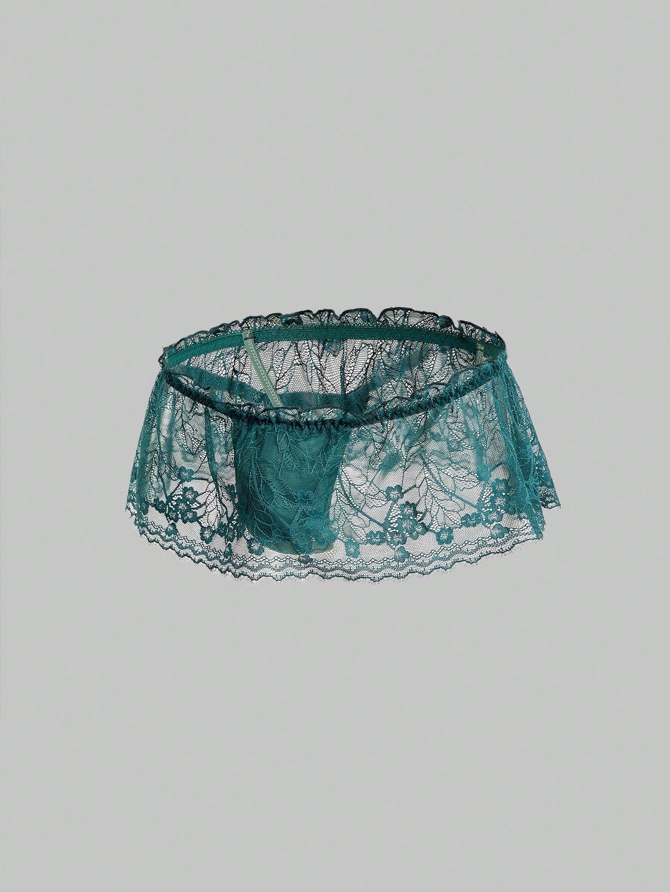 Men's dark green low-rise thong underwear with contrast lace, semi-sheer detailing, and random print design.