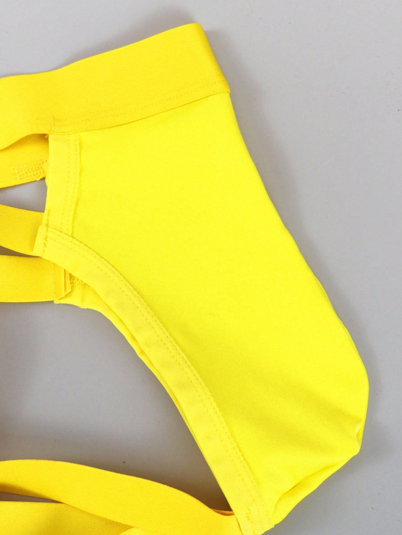 Men's low rise jockstrap underwear with cut out detail and colorblock design in medium-stretch knitted fabric