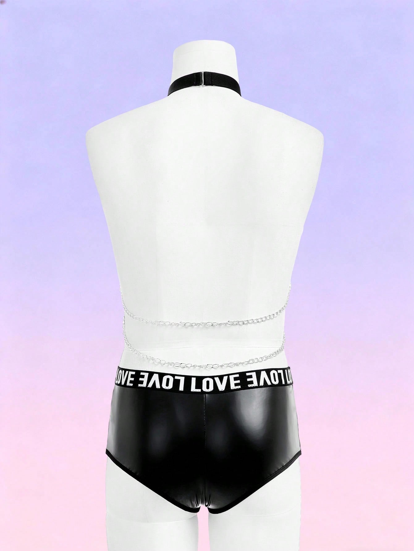 Black men's mid-rise briefs with letter woven strap, backless knot and tape details, and chain necklace