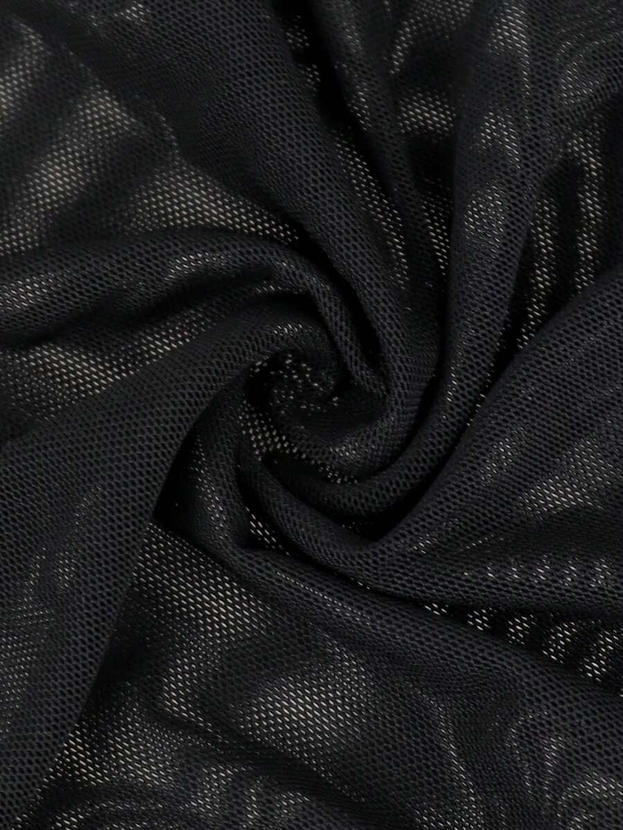 Black mid-rise mesh briefs for men featuring a hollow lace design and colorblock pattern.
