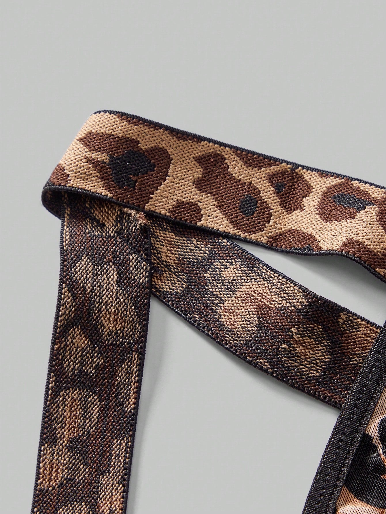 Men's leopard print mesh lingerie set with short vest, leopard tape details, knot accent, and low-rise thong.