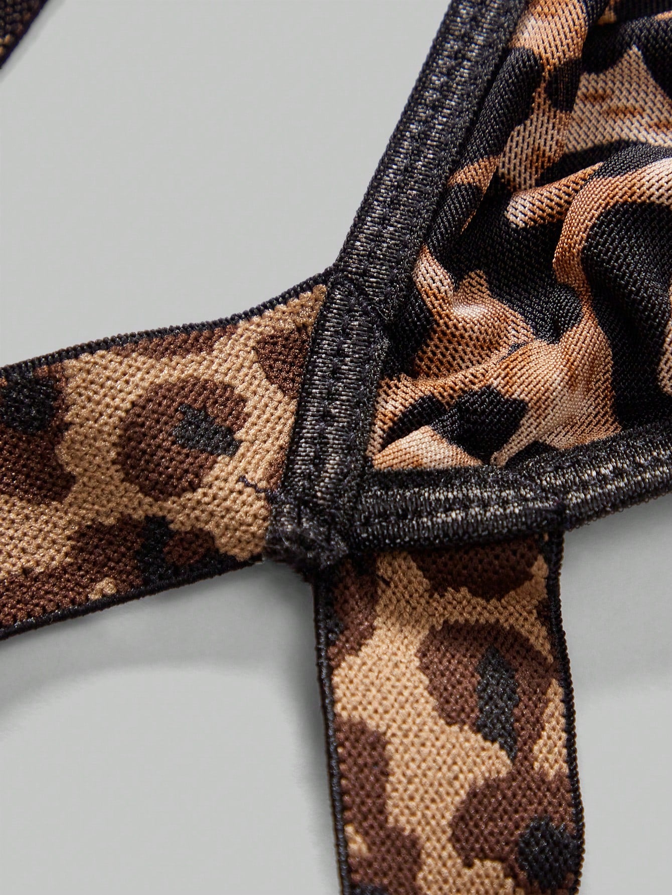 Men's leopard print mesh lingerie set with short vest, leopard tape details, knot accent, and low-rise thong.