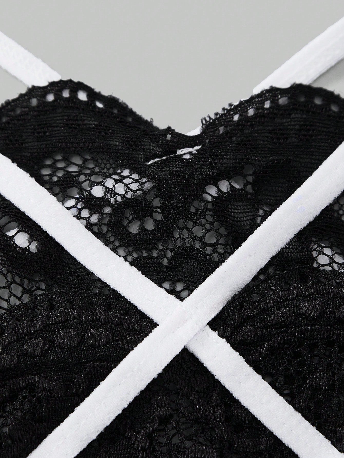 Men's black lace thong underwear with sheer details and bowknot ribbon accent, low-rise semi-sheer design