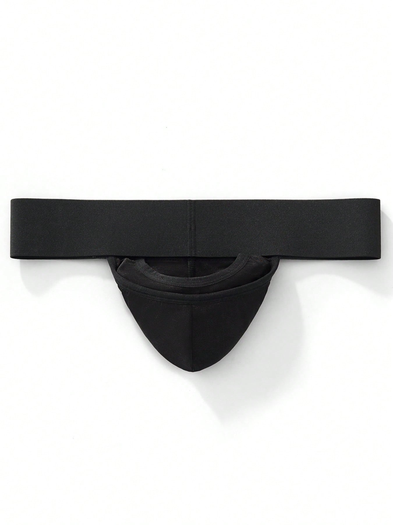 Men's black low-rise thong underwear with wide waistband and letter pattern, made from medium-stretch fabric.