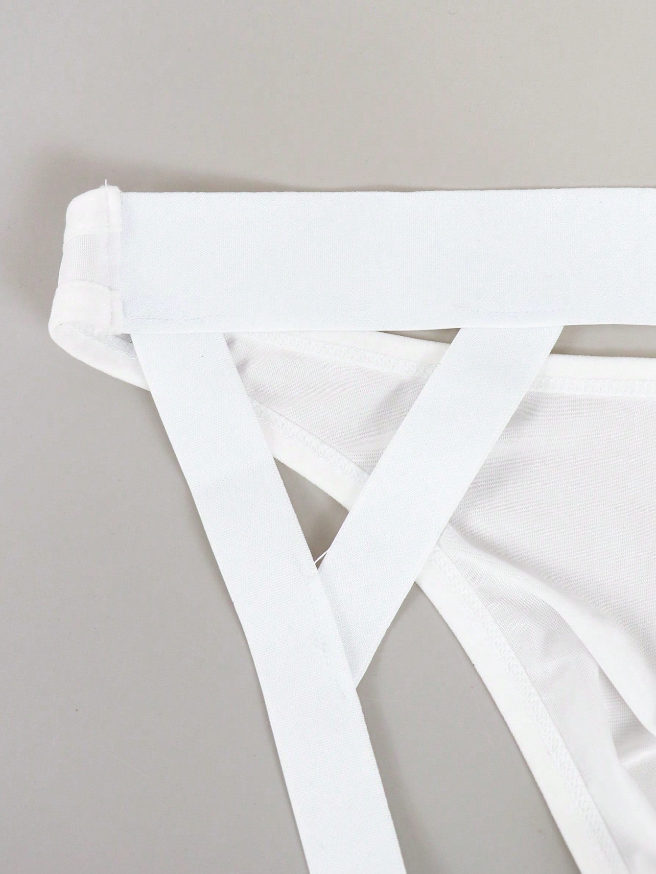 Men's solid color hollow breathable jockstrap underwear with a low-rise brief-style front and minimalist design
