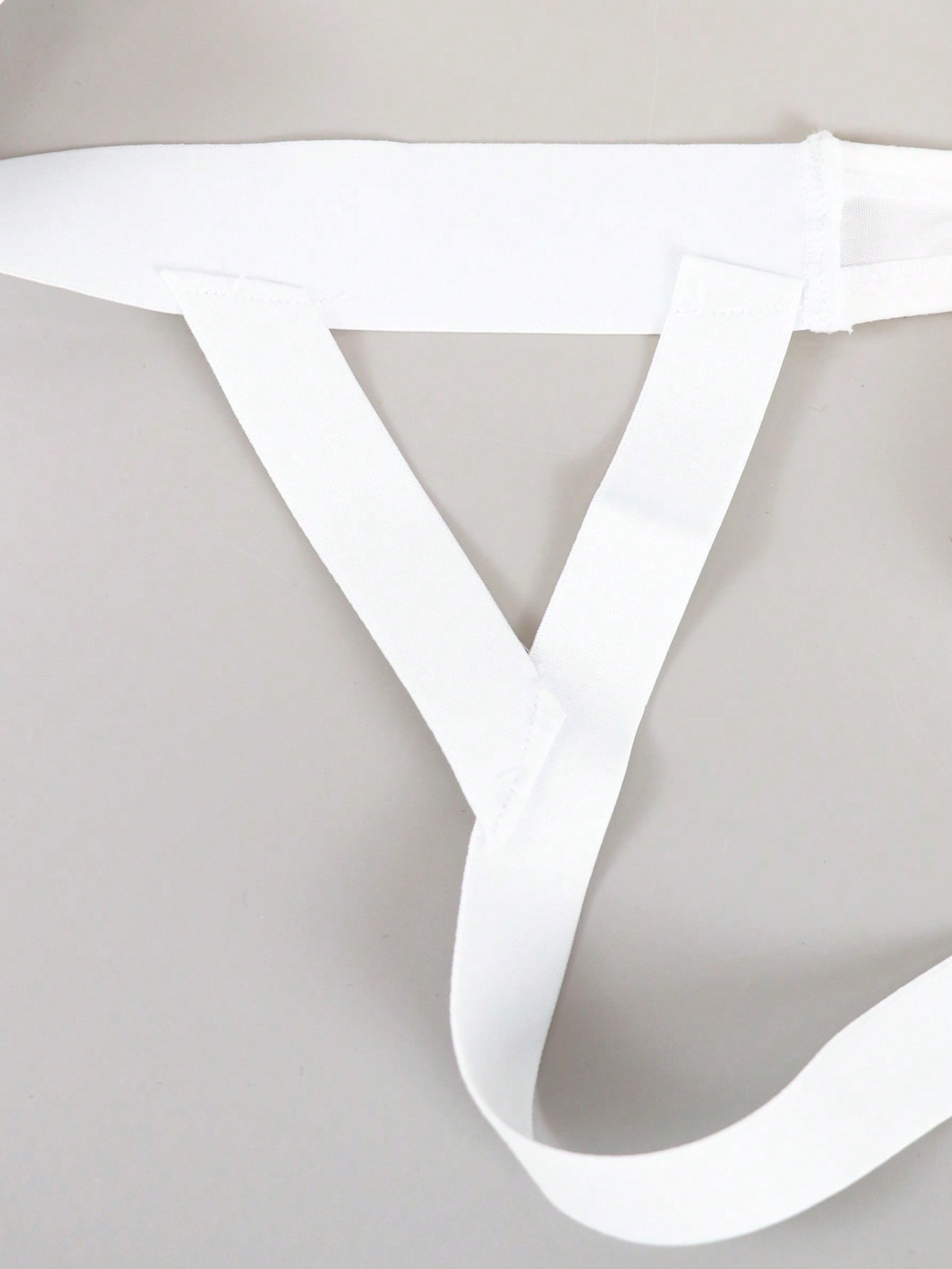 Men's solid color hollow breathable jockstrap underwear with a low-rise brief-style front and minimalist design