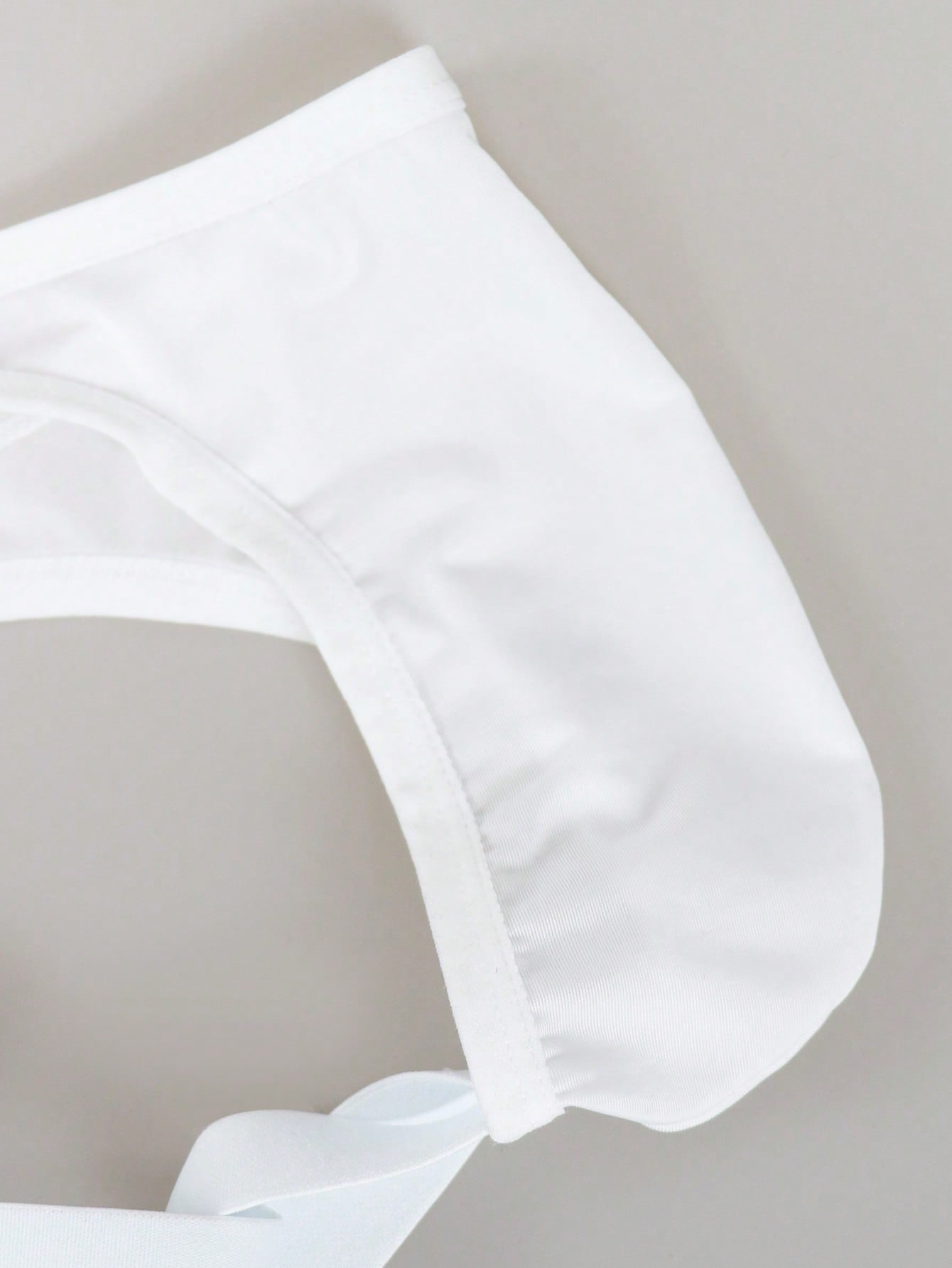 Men's solid color hollow breathable jockstrap underwear with a low-rise brief-style front and minimalist design