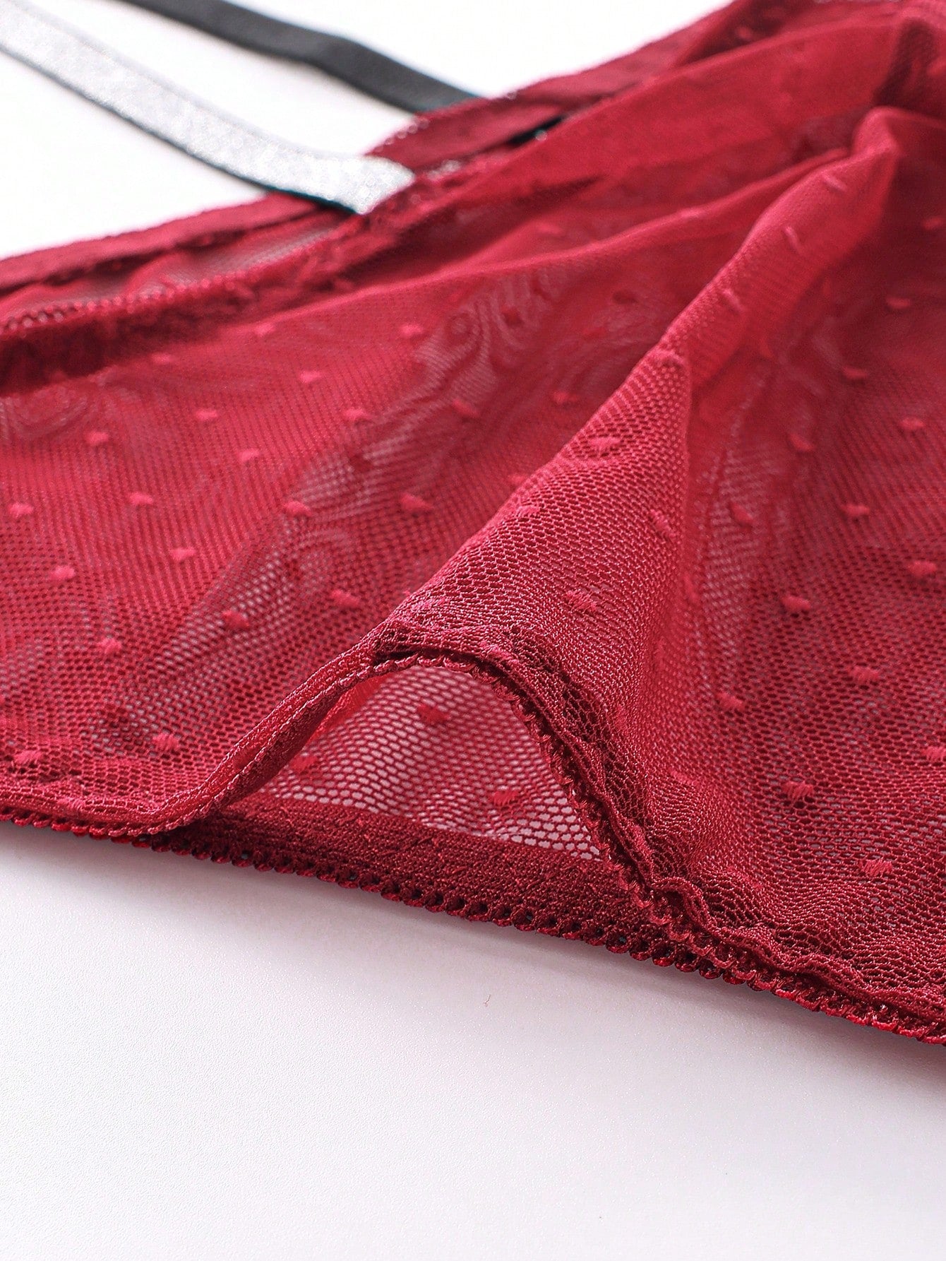 Men's burgundy low-rise lace trim briefs with a geometric pattern and semi-sheer knitted fabric