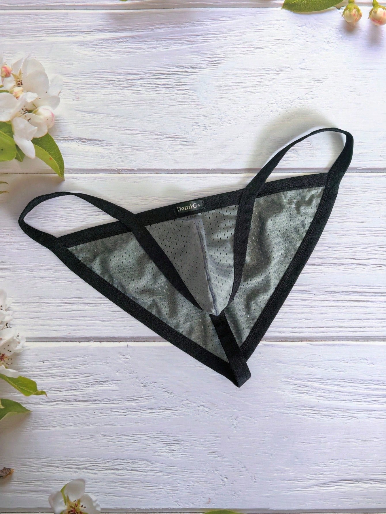 Men's grey sheer mesh low-rise briefs with hollow-out detail and letter pattern