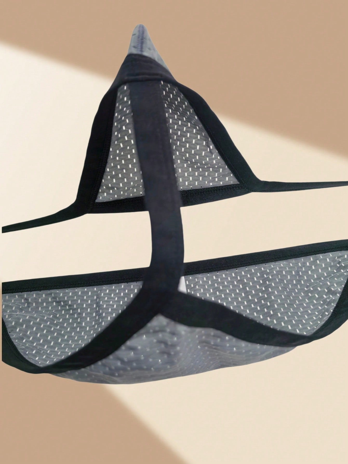 Men's grey sheer mesh low-rise briefs with hollow-out detail and letter pattern