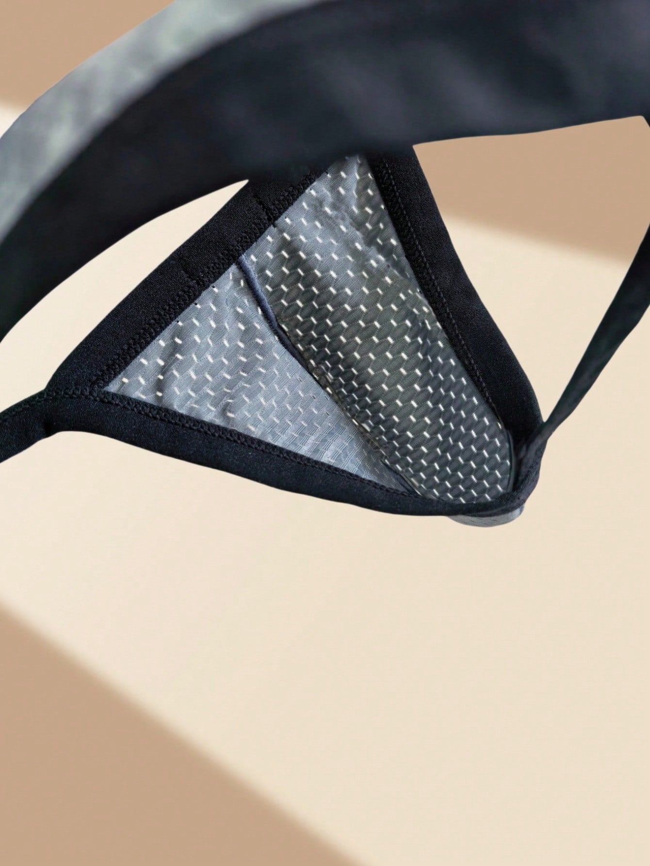 Men's grey sheer mesh low-rise briefs with hollow-out detail and letter pattern