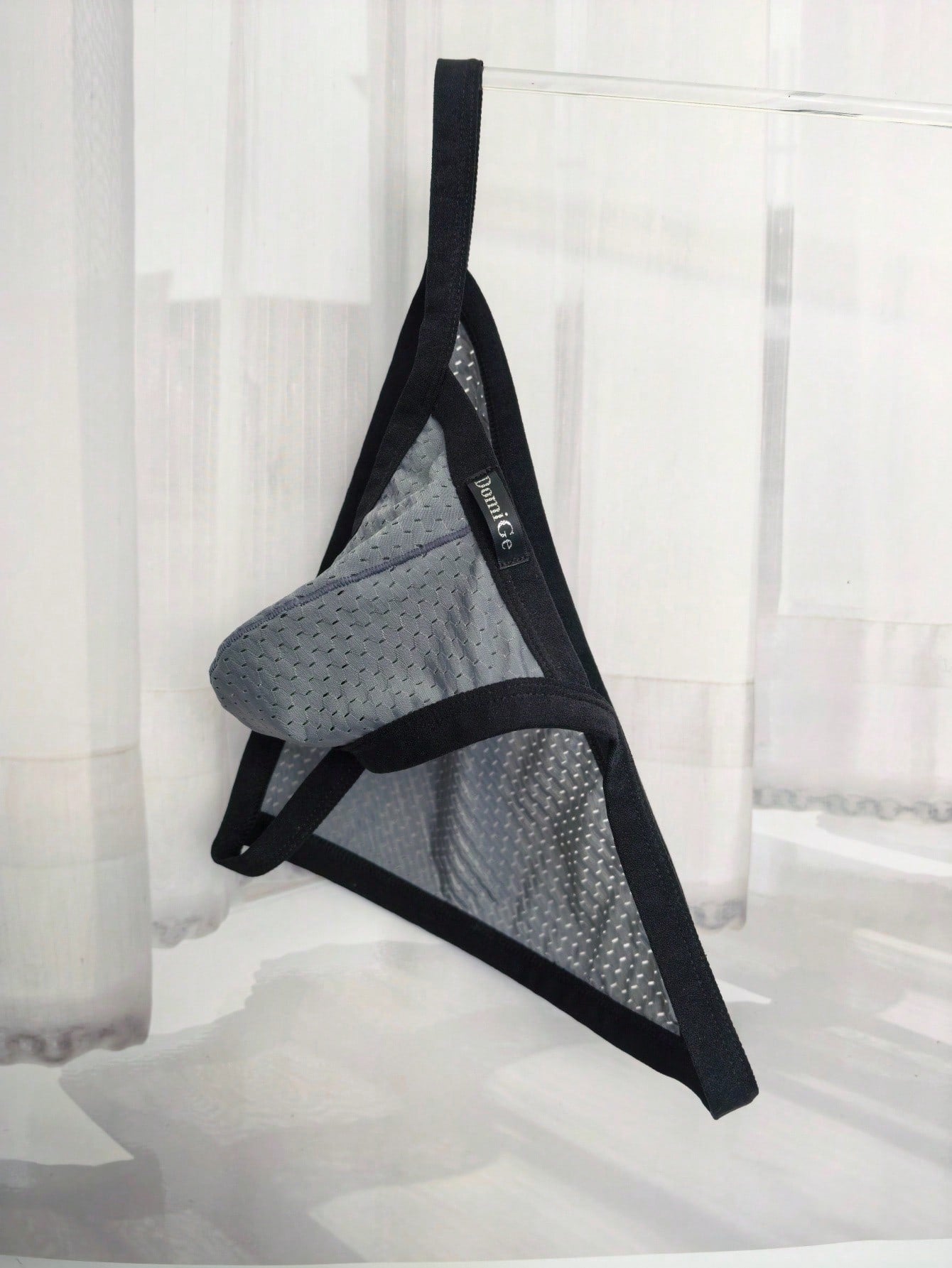 Men's grey sheer mesh low-rise briefs with hollow-out detail and letter pattern