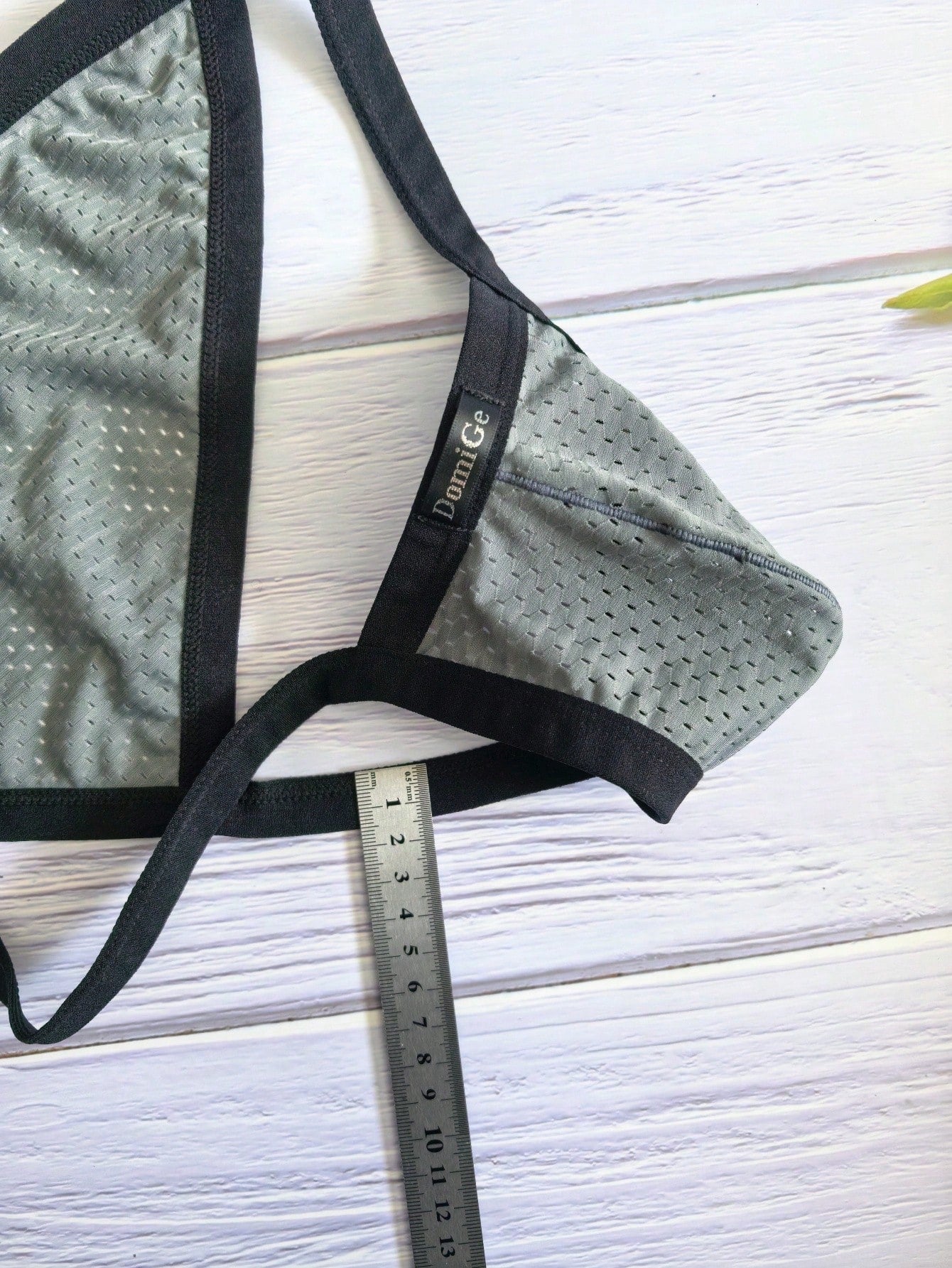 Men's grey sheer mesh low-rise briefs with hollow-out detail and letter pattern