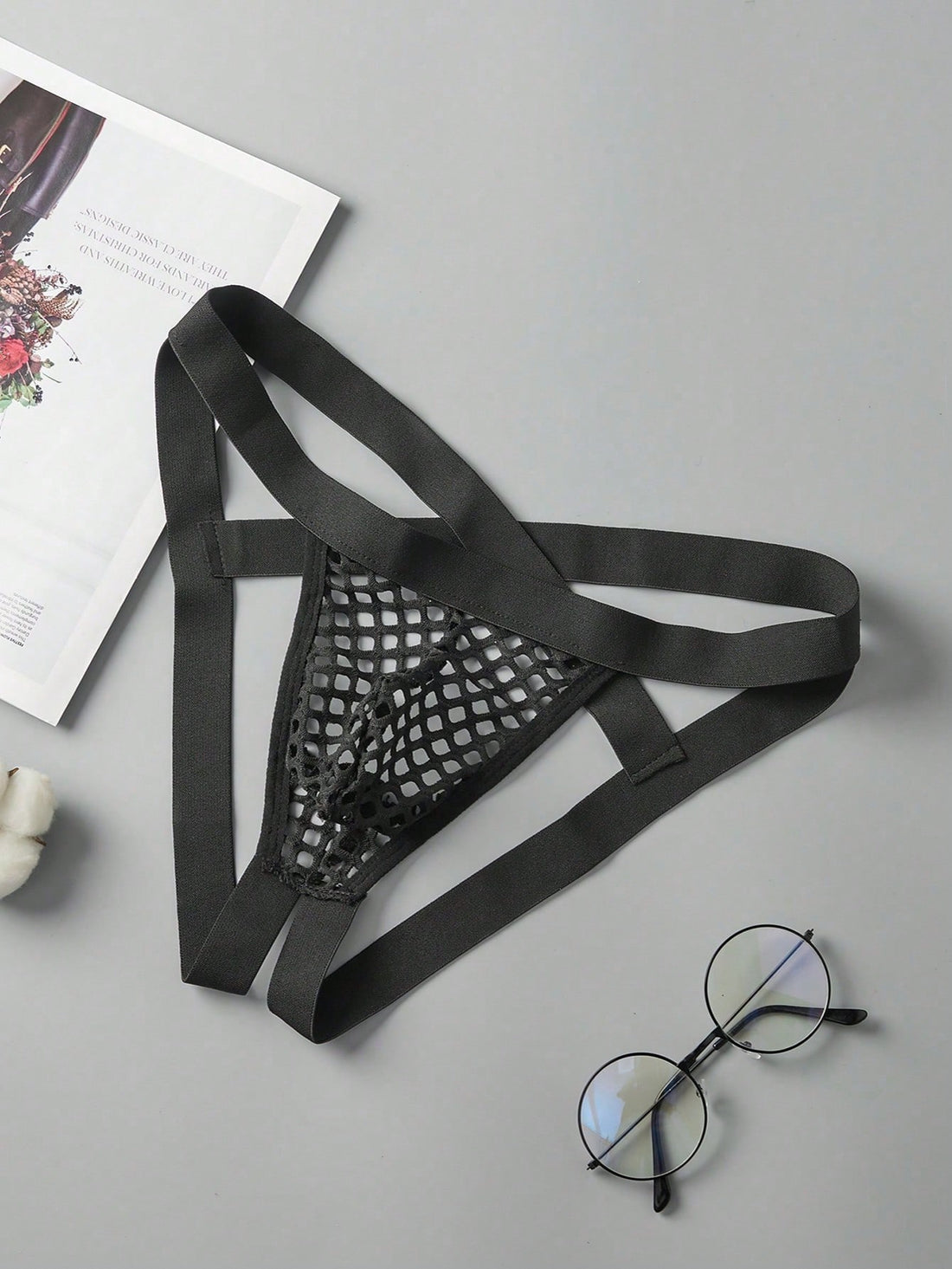 Men's black semi-sheer mesh double thong jockstrap with criss cross straps, cut out details, low rise fit, and geometric pattern.