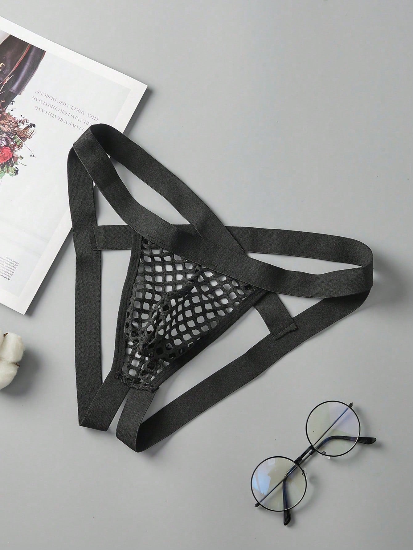 Men's black semi-sheer mesh double thong jockstrap with criss cross straps, cut out details, low rise fit, and geometric pattern.