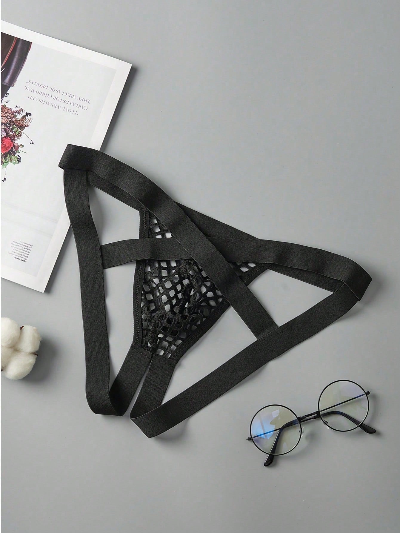 Men's black semi-sheer mesh double thong jockstrap with criss cross straps, cut out details, low rise fit, and geometric pattern.