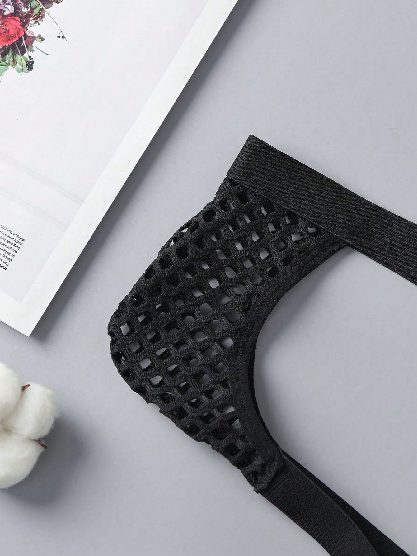 Men's black semi-sheer mesh double thong jockstrap with criss cross straps, cut out details, low rise fit, and geometric pattern.