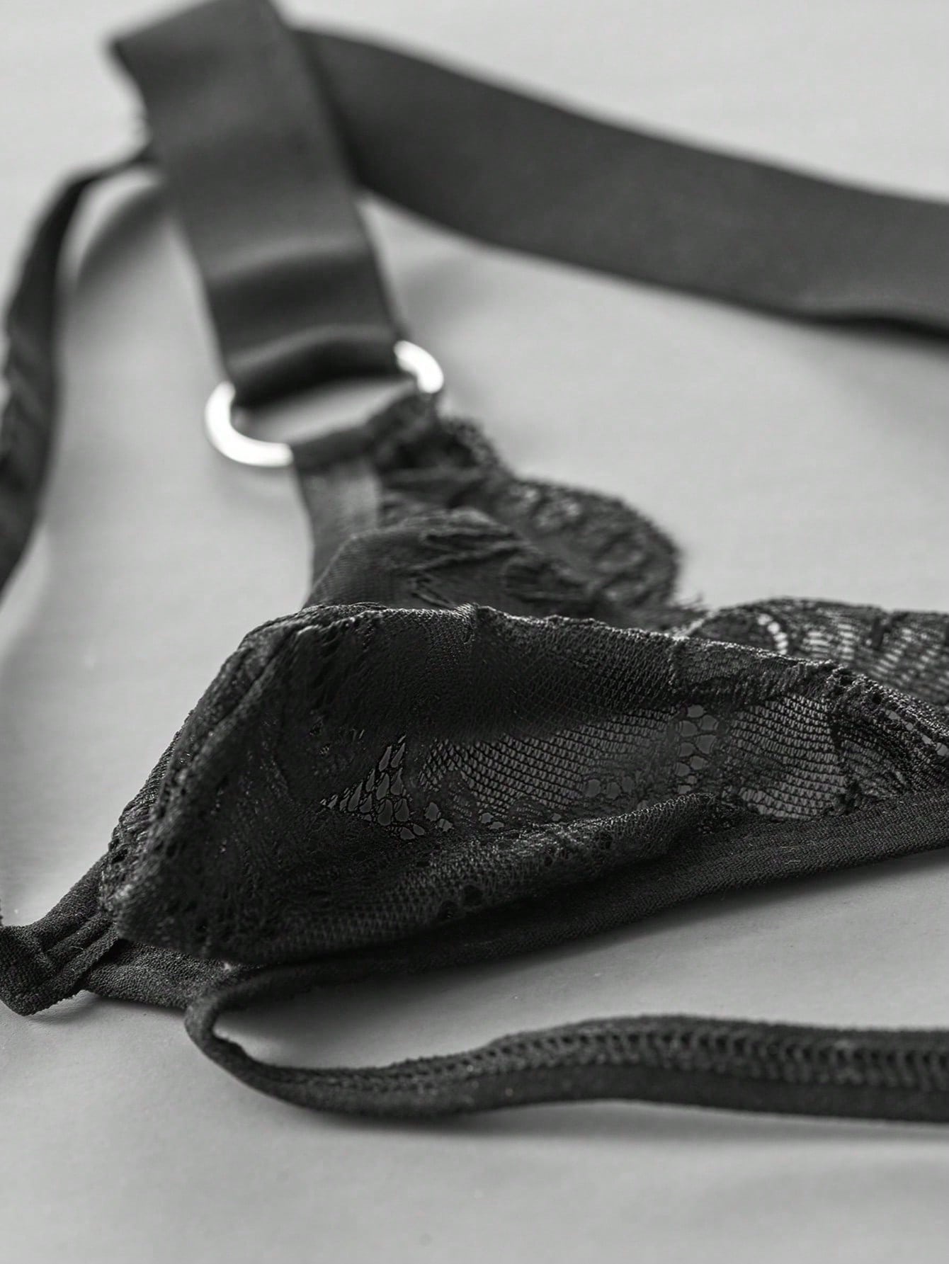 Men's black lace low-rise jockstrap thong with contrast lace, hollow-out details, and semi-sheer plain design