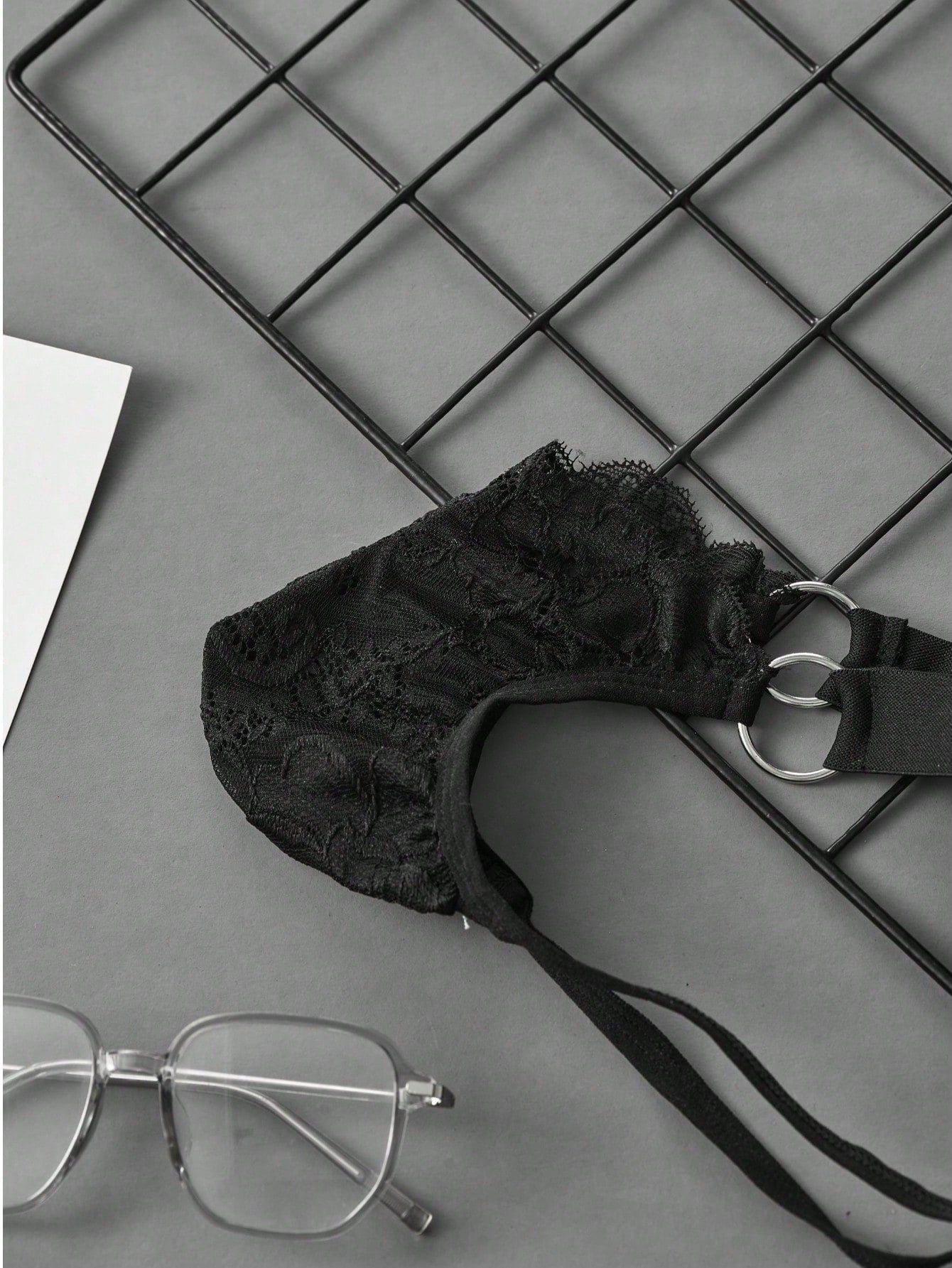Men's black lace low-rise jockstrap thong with contrast lace, hollow-out details, and semi-sheer plain design